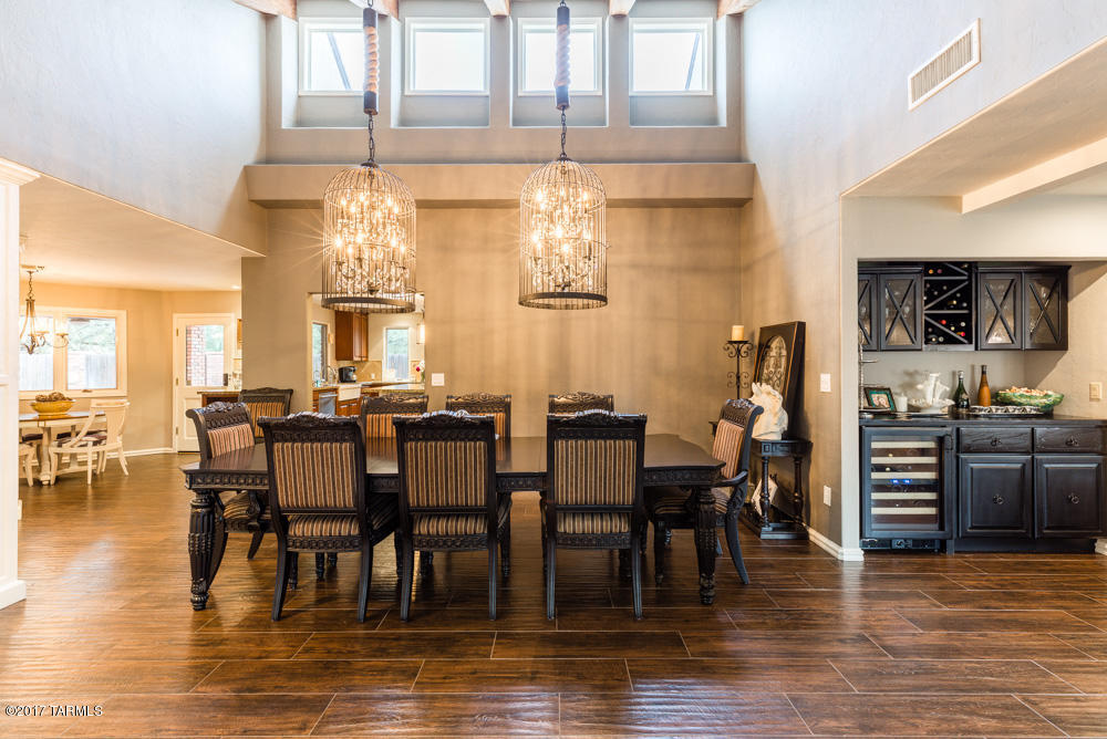 Stunning, rare Tudor house in Tucson Country Club Estates. This house has been completely remodeled from floor to ceiling.  The custom front door sets the scene for a dramatic entrance followed by the formal dining room with elegant birdcage chandeliers.  The floor plan is open with a spacious living area. It welcomes you with the cozy warmth of a well loved home.  This home has 5 bedrooms and 4 baths.  The back yard is a golfers dream with 3 practice putting greens, swimming pool and spa.  Renovations include brand new roof, new porcelain wood style tile throughout, new custom Thermador refrigerator, new custom wood built in bar and bedroom closet & so much more. Owner/ Agent Two land parcels totaling 4696 sq ft adjacent to property will convey. Total lot square footage is 19,506. This house is move-in ready and should not be missed.