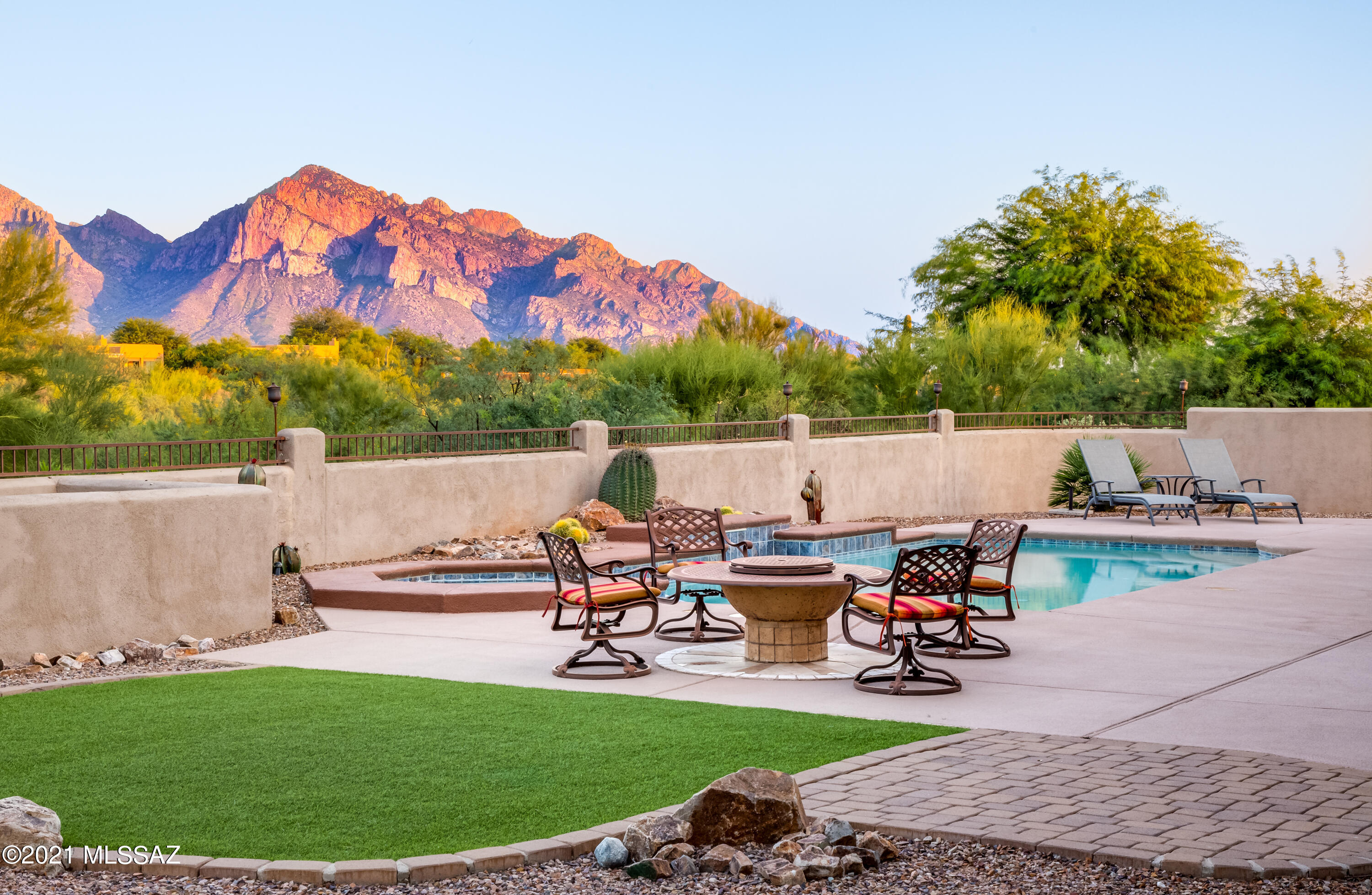 Enjoy amazing unobstructed Catalina Mountain views from impeccably maintained & tasteful contemporary home in Tangerine Heights-Oro Valley. Home offers spacious owners suite +3 additional bedrooms, formal living room & dining room, beautiful family room open to wet bar & kitchen, travertine flooring, alder cabinets & oversized 3-car garage. Extended covered patios, built-in outdoor kitchen & solar heated pool/spa all offering panoramic views. Exterior & interior living space affords fantastic flexibility for day to day living as well as entertaining. Recent improvements include 2 high-end Lennox HVAC systems (2018), 2 new Rheem hot water heaters (2018), freshly re-coated pebble tec pool w/new pool & spa automation system (2019) & re-coated roof (2021), new carpeting & fresh interior paint.