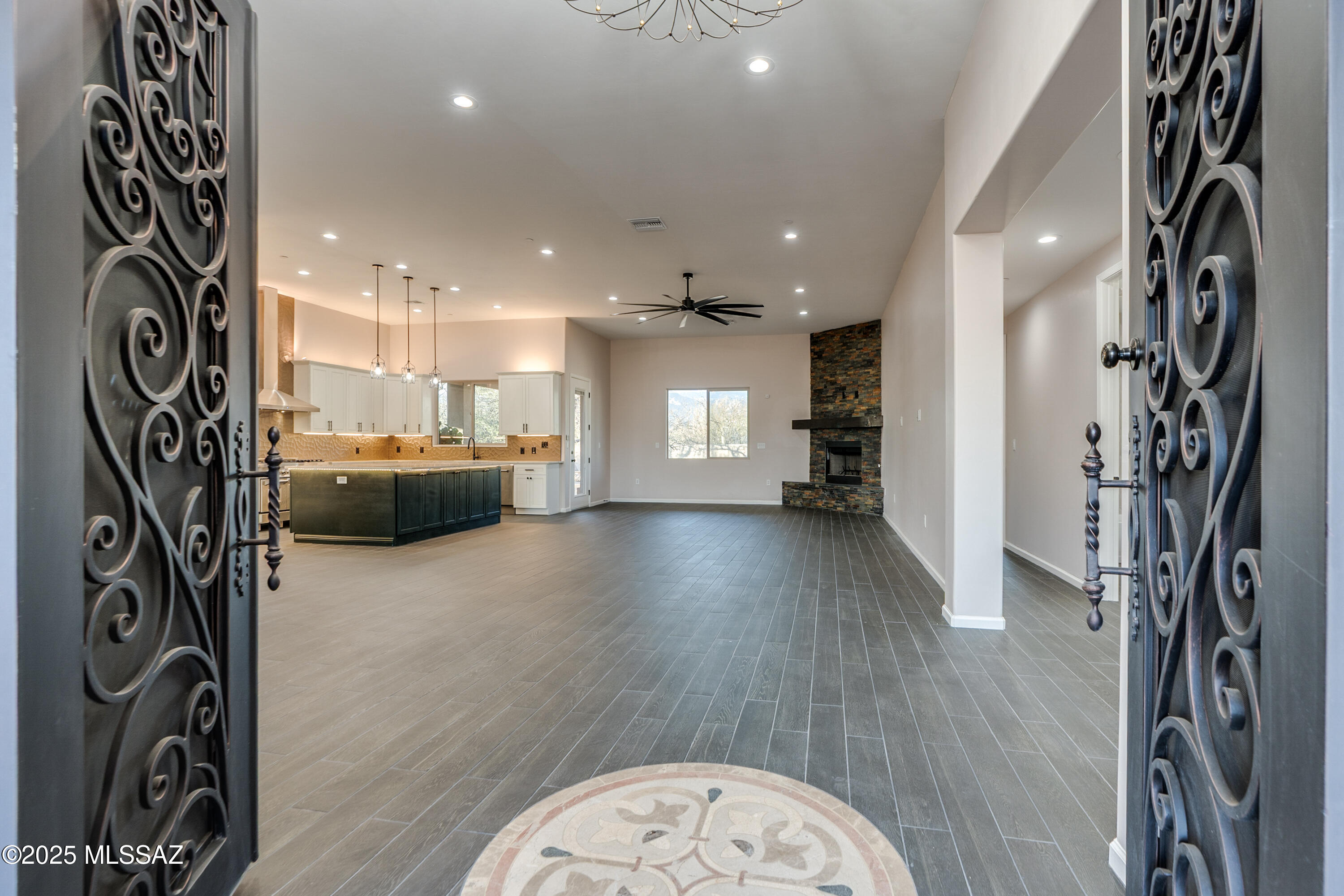 Seller will accept or counter offers between $999,990 and $1,045,000 ''El Rancho Merlita''~A Quaint Gated Subdivision w/16 Lots nestled in Lush Mesquite Groves. A Community created w/the Idea of each Home having its Own Unique ''Flavor''. This 2024 Custom Built Home is no exception. Exterior is Warm & Inviting Blending Seamlessly w/the Beauty of the Tucson Desert. Located at the end of a cul-de-sac, .48 Acres w/Landscaped Front Yard & Irrigation. Beautiful Brick Paved Driveway & Walkway lead to Large Court Yard. The Fountain is a Peaceful Greeting as you approach the Sensational Grand 8' Iron Double Entry Doors. WELCOME HOME~Stunning 3041 sqft, 4 Bed/3 Bath + Powder Room. Open Style Living at it's Finest. Expansive Great Room w/Wood Burning Gas Fireplace is the Hub connecting Dining Area Wet Bar, & Gourmet Style Kitchen. Wet Bar complete w/Wine Fridge-

Beverage Center, Glass Doors w/LED Interior Lighting, & Electric Fireplace Creating Fantastic Dining Ambiance. To Heat or not to Heat, your choice.

Kitchen Features Zline SS Appliances including 48" Dual Fuel 6 Burner Range, w/Griddle & Double Oven, 30" Microwave Drawer, & a Pot Filler! Exquisite Island w/Cabinetry on Both Sides & Bar Seating. "Arc" Cabinetry, "Le Blanc" Quartzite from Brazil, Gorgeous 3 Dimensional Backsplash in "Allure Bronze", + Under & Over Cabinet Lighting. All Creating a Space you Want to be in.

Primary Suite - Spacious w/Back Patio Access, Built in Electric Insert Fireplace, North facing Views. Primary Bathroom - Double Vanity, Quartz Counter Tops, Jetted Tub, Fantastic Walk in Shower w/2 Shower Heads & Bench Seating. Large Custom Closet that leads to an additional area of Tranquility...Your Own Infrared Dry SAUNA. Just One of the many Perks this Home has to Offer.

Split bedroom FloorPlan for added Privacy Offers 3 Additional Bedrooms & Full Bathroom w/Double Vanity. One of these Bedrooms has a Double Door Entry w/Ensuite - Possible Den, Office, Guest Room - You have Options.

Fully Enclosed Spacious North facing Backyard, Large Covered Patio w/Brick Pavers, 2 Ceiling fans, Wall Fountain, & Pre-Plumbed (Gas, Electric, Water) for Possible Future Outdoor Kitchen.

Extended 3 Car Garage w/ Epoxy Floor & Outlet for Electric Car Charger. "Milgard" Dual Pane Windows. Builder Warranty. So Much to say about this Exquisite Home w/Attention to Detail throughout. Come Tour this Home and See for yourself!