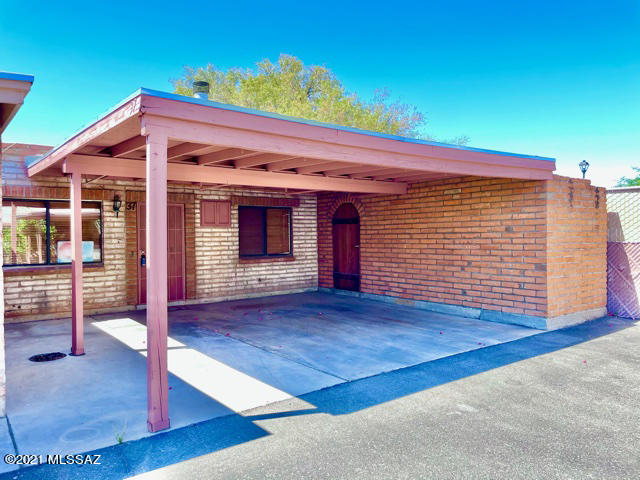 Check out this cute 2br/1ba townhome in central Tucson! This is an end unit that boasts granite tile counters and eat-in kitchen, fireplace in the great room, 2-car carport and relaxing, easy-to-maintain & private yard with storage shed, and a waterfall pond for ambiance. The Northgate Townhomes community is quiet & friendly, with a gated pool for residents. Stores and other conveniences are within walking distance.
