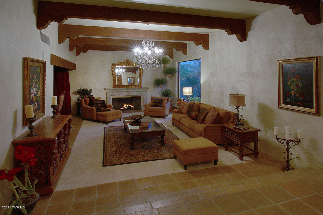Outstanding 4126 sqft, 5 bedroom burnt adobe territorial in Catalina Foothills Estates #8 built by La Quinta and lovingly remodeled and expanded by McCaleb Construction (featured on This Old House). Located on a quiet cul-de-sac on a 1.84 acre lot, this all masonry home offers beamed and corbelled ceilings, concrete tile floors with brand new carpet, remodeled gourmet kitchen with granite counters and large center island, two ovens and warming oven, three fireplaces, gracious master suite with remodeled bath and beehive fireplace. Roof recoated in 2013, 2 tankless water heaters, Halo water treatment, wired for sound system Four garage spaces, expansive rear yard with two covered patios, ramada, pool and spa, spectacular views of the Catalina Mountains and Catalina Foothills School District