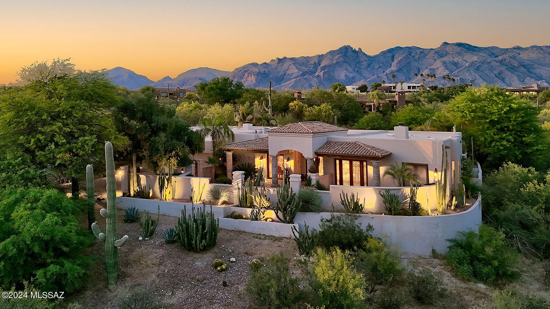 This stunning Spanish Colonial masterpiece by Nelson Builders is nestled in prestigious, guard-gated Hacienda Del Sol Estates in the Catalina Foothills. Located on a 1.3-acre interior lot away from traffic noise, this 4 bedroom+office+media room (that could be a 5th bedroom) home features quality construction and ''Old World'' charm throughout. Highlights include hand-built, one-of-a kind, exterior wrought-iron and interior antique doors & pillars. Additional features include custom cabinetry handmade in Mexico, faux painting, crown molding, Fortuny and Scudo Saraceno Glass Pendant light fixtures, custom lighted bookshelves, and hand carved cupboards - historic finishes not seen in today's contemporary style homes. The gourmet island kitchen offers granite counters, copper cabinet doors and designer appliances. The spacious family room, open to the kitchen, offers a dramatic fireplace with a custom mantel. The primary suite features a 2-way fireplace, a sitting room, and a luxurious primary bathroom with a spa tub, a hand-painted ceiling, an antique vanity with dual sinks & a large walk-in closet. The media room has a 109" projection TV with speaker system and a full bathroom. The office, with separate entrance, has built-ins including 2 computer desks. The 3-car garage offers a storage room and built-ins. Enjoy the beautiful grounds featuring a covered front & back porch, fountains, a sparkling pool/spa/waterfall, and an outdoor cooking area.