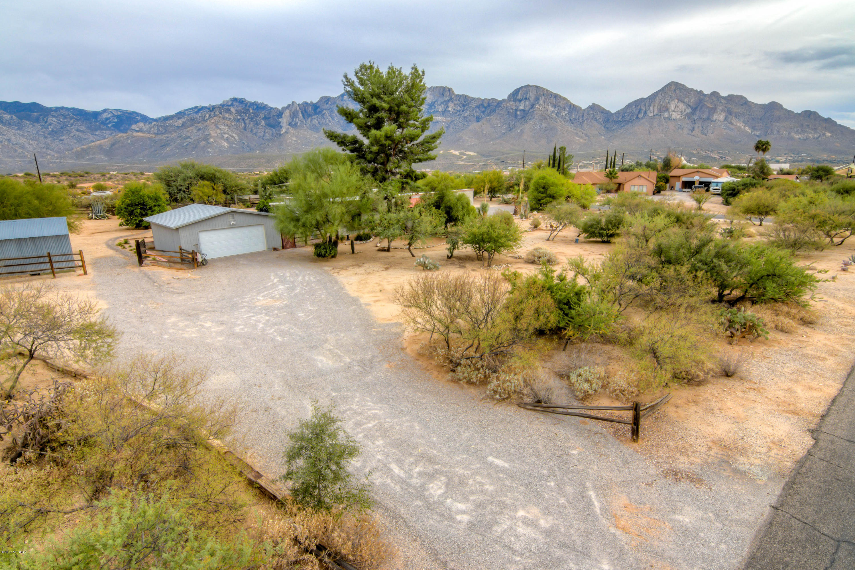Amazing country living in the heart of Oro Valley. Property is situated on a Beautiful Acre w/ Exquisite Mt Views from master, az room, and back patio. Well maintained open floor plan. Fenced backyard. New roof and windows. Lots of parking with 2 car detached garage and 2 covered car port. Great work space for all your tools and large shed for storage. RV parking available on both sides of lot. Has both A/C and evaporation cooler depending on season. Situated on corner lot. Close to shopping, movies, and schools.