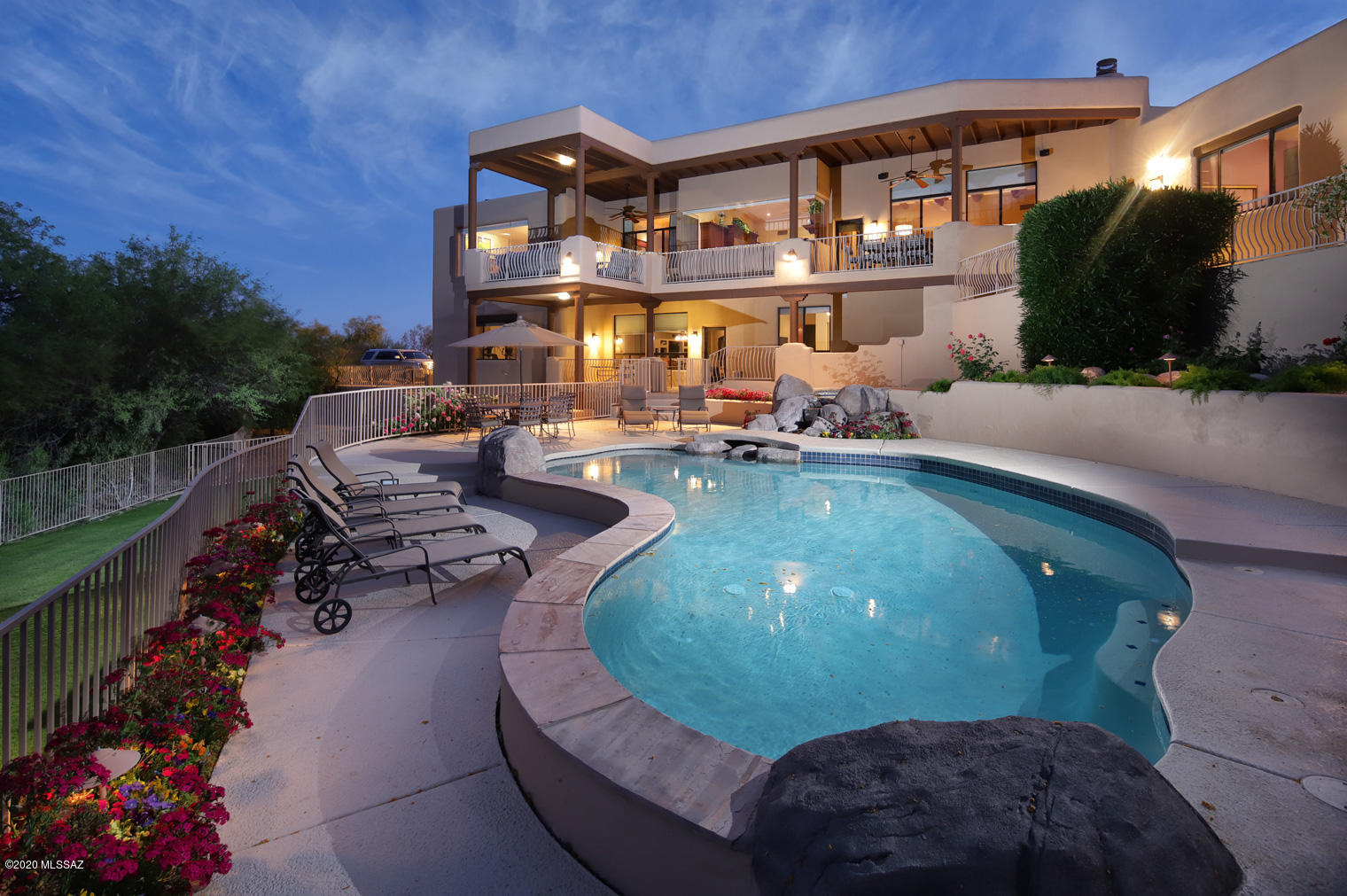 Enjoy unobstructed, jaw dropping mountain & golf course views from this spectacular SW home on a private, elevated cul-de-sac in prestigious Ventana Canyon Estates. This 6bed/5bath, 4 car garage w/office & lower level rec room is an entertainer's dream. Main living areas showcase Brazilian cherry flooring. Large formal dining room opens to living room w/ stacked stone FP,  dramatic full bar, & incredible mountain views through over sized seamless windows. Seamless windows continue in expansive chef's kitchen w/ SS appliances, bar seating at island, cherry cabinets, & granite counters. Wrap-around deck off en suite  master w/ fireplace showcases views of back yard w/ pool/spa. Wine cellar on lower level is any wine aficionado's dream featuring wet bar & cork flooring.