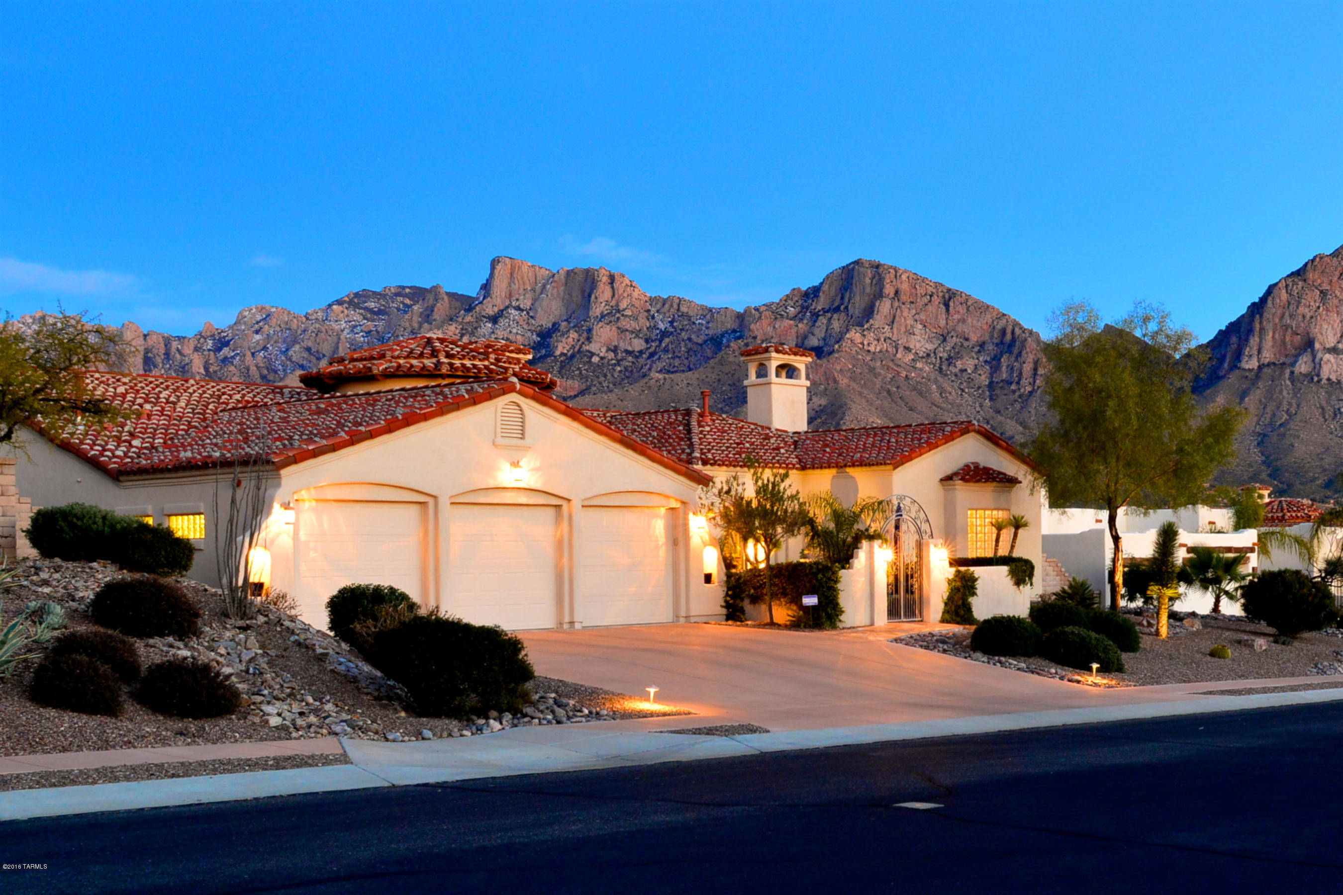 Gorgeous SW style home features fantastic in your face Catalina Mtn views & City lights! Enter thru large front ctyd into a spacious great room/gourmet kitchen w/wall of windows showcasing the mtn views. Formal liv/din rms. Alder cabs, granite slab tops, Canterra f/place, travertine floors, new wood floors in liv rm & den/4th br, newer carpet in other br's. Secluded master suite features sitting area w/f/p, tiled bath w/sep vanities & closets, lg garden tub, glass block, door to patio. Vacation in your own bkyd with sparkling pool/elevated spa spilling into pool, putting green, gas f/p, built-in BBQ & frig. Gather around the gas f/p & enjoy spectacular views. Beautifully landscaped front & rear. Stunning Canterra tiled front ctyd & rear expanded patio. Meticulous and a cut above!