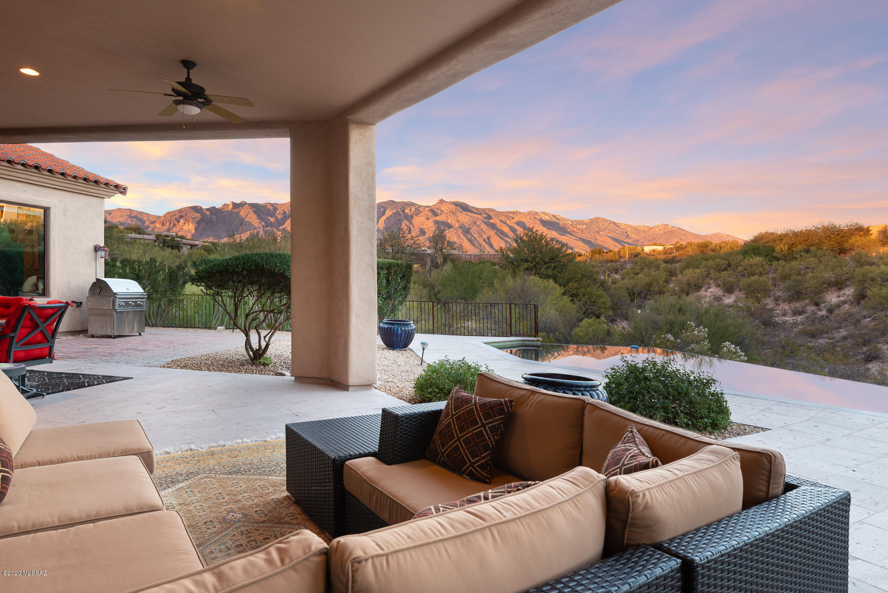 Views! Views! Views!  Beautiful 2006 custom hm privately gated on a 2.15 acre private lot in the heart of the Catalina Foothills. Lovely architectural presence w/artisan touches throughout, this spacious home has an open split bdrm floor plan. 4 bdrm + bonus rm. Enter from a circular drive covered in pavers. Charming fountain, gated entry to the courtyard, beautiful metal & glass dbl front doors. Impressive foyer reveals view of mtns. 2 open living areas & wetbar w/wine ref. spacious kitchen w/top finishes & appliances, island, breakfast bar & dbl dishwashers. Master suite w/fp, wonderful bathrm w/custom closets, dbl vanities & jacuzzi tub. Two ensuite guest bedrooms, polished stone flooring, solid knotty alder 8' doors. Outside private infinity edge pool & spa, canterra patio, & mtn views Four flat screen tv's included. District #16 schools. Located minutes away from world class La Paloma Golf Resort & Country Club, the best shopping & restaurants in Tucson. Quick access to the University of Arizona & Downtown.
