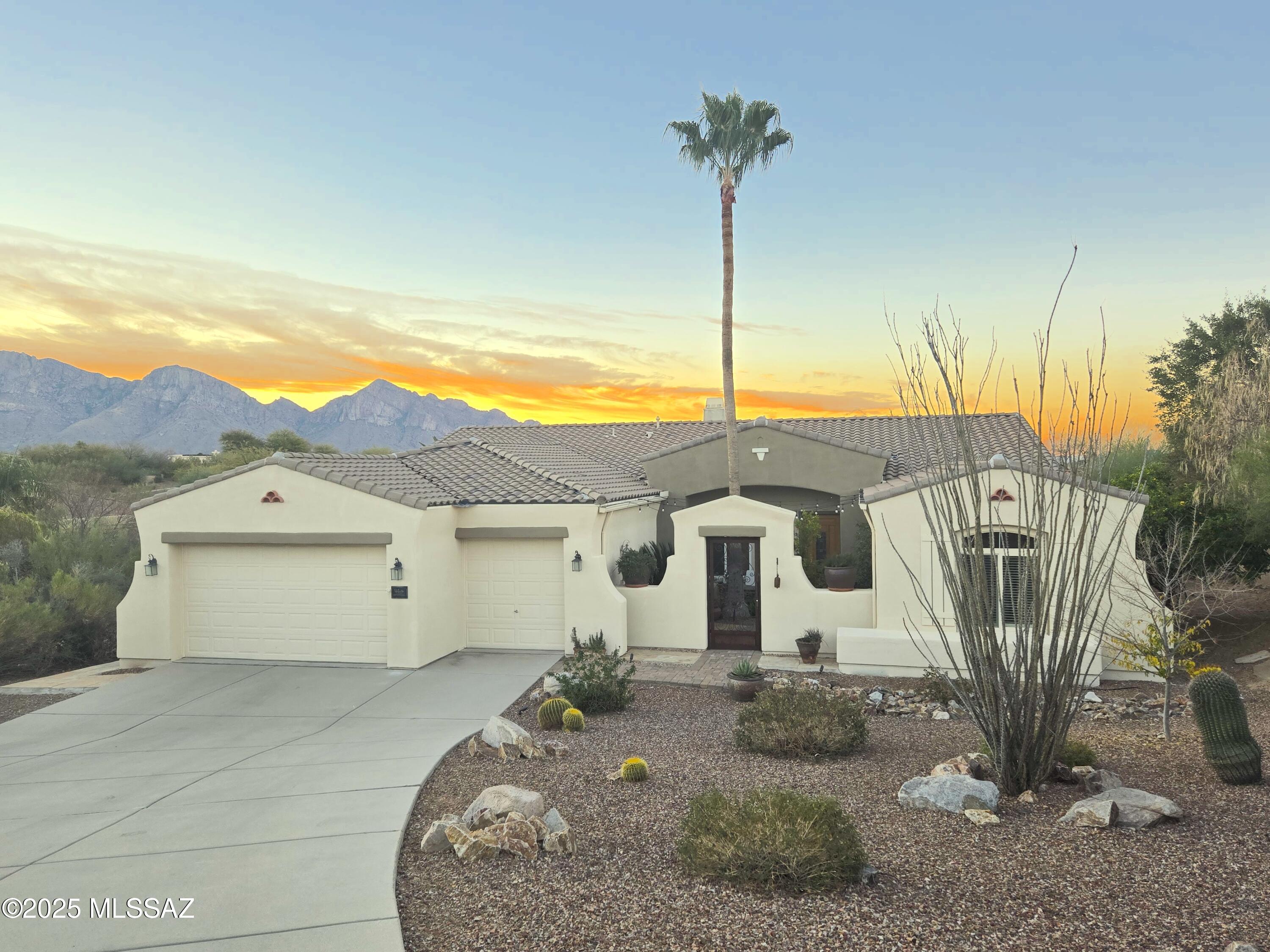 A lush, green oasis in the heart of Oro Valley, this exceptional home on a premium lot boasts inviting courtyard, sparkling pool/spa & captivating mountain views. This exquisite home offers 4 bedrooms, 3 full baths + office/den. Entertain in the elegant formal living/dining room or retreat to a large gathering room w/corner fireplace, view windows and gourmet 'island' kitchen w/granite & stainless amenities. Spacious Owner's suite w/sitting room offers large view windows, dual vanities, jetted tub plus large walk-in shower & closet. Private guest quarters with en-suite bath. Magnificent outdoor setting is unsurpassed with an extended covered patio, heated pool and spa, covered BBQ station, lush green lawn, palm trees & views! Recent upgrades include Lennox HVAC system, exterior painted, and freshly painted 3-car garage with new LED lighting & epoxy floor. Home has been meticulously maintained. Located in a beautiful neighborhood that is walkable and close to everything Oro Valley has to offer. This luxury oasis is perfect for the most discerning buyer.