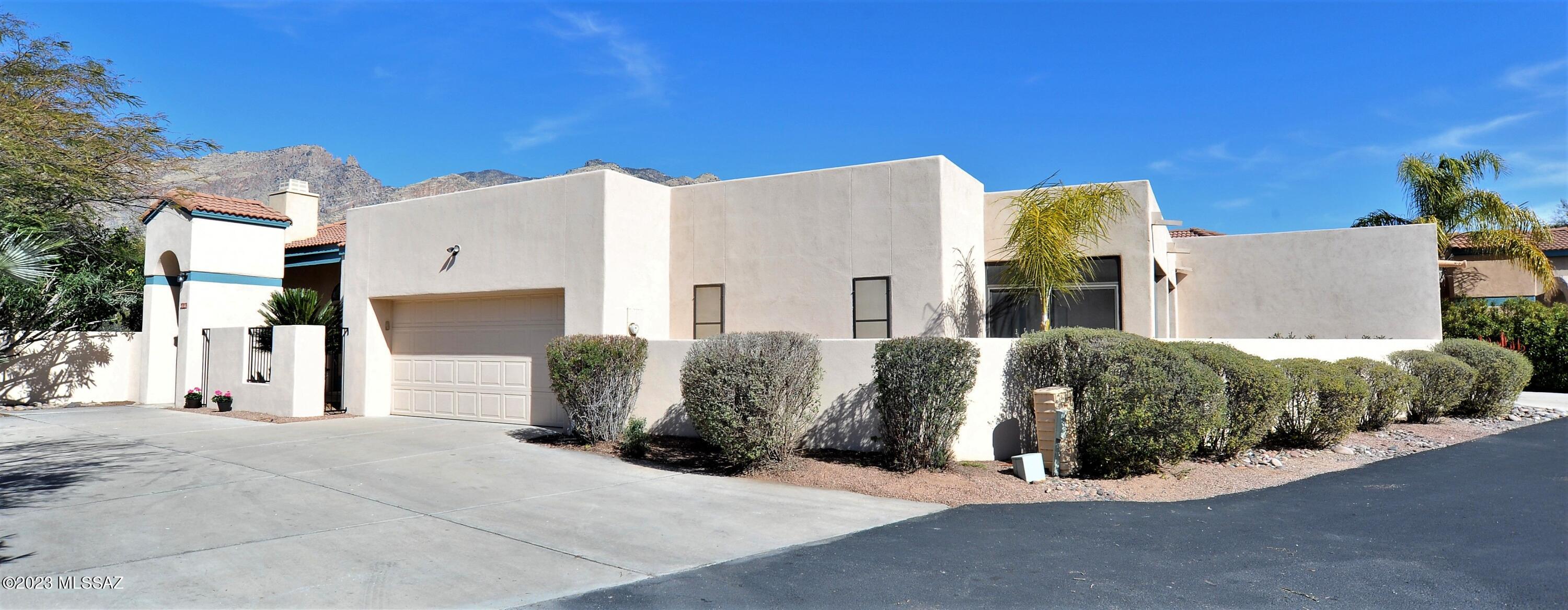 Beautiful Catalina Foothills Townhome Located in Desirable Kachina Hills! Come and see this wonderful home which sits on a premium private lot with extended driveway & backyard oasis retreat surrounded by Majestic Mountain View's! This home features a spacious open and bright floor plan with vaulted ceilings, kitchen includes Corian countertops & luxury Cafe fridge, Eviro whole house water filtration system, large primary suite with double vanity, separate large walk in shower and garden tub, spacious walk in closet & has access to extended covered patio & AZ room. Home has been freshly painted to interior and exterior, immaculate & move in ready. Community offers an inviting sparkling swimming pool & spa! Great opportunity for owner occupied, vacation home & investment. A true must see!