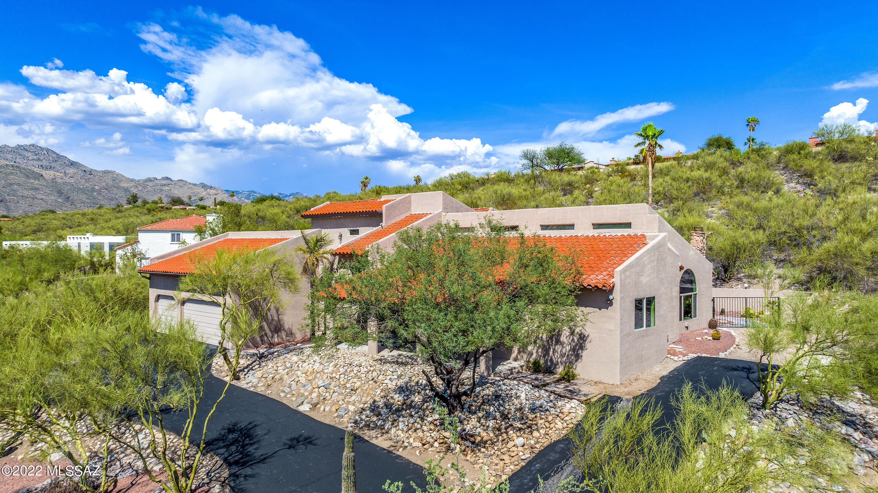 Pristine elevated lot in the Sunrise Territory Village in the Foothills with amazing breathtaking city and mountain views.  You'll be greeted by lush desert landscaping, eye-catching stonework. Enter the remodeled home and find elegant dining & living areas with attention to detail. Be welcomed into the light and bright great room featuring a fireplace with floor to ceiling modern stone accents. The gourmet kitchen provides an abundance of cabinet space with gold detailing throughout, granite countertops, and new electrolux stainless steel appliances. Enjoy formal style dinners under the golden chandelier. Guest bedrooms are located downstairs, generously sized with great closet space. Upstairs you will  enter the private primary suit with access to the rooftop balcony overlooking the pool. The luxurious en-suite bath features a double vanity, separate shower, freestanding tub, and gold fixtures. Relax outside under the covered patio and take a splash in the pool/spa. The driveway has been freshly coated with asphalt and leads to the spacious 3 car garage! Make this your dream home today! Owner is a licensed agent.