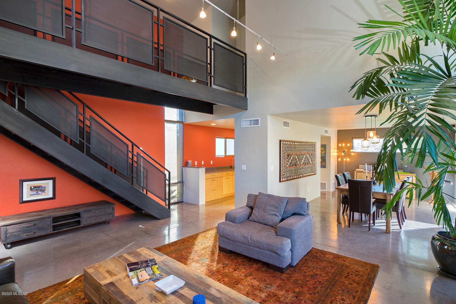 Great Price! Beautifully updated modern midtown home designed by Rob Paulus is ready to move in! This 3-bedroom, 3-bathroom home features a spacious courtyard, high ceilings, upgrades throughout, concrete and hardwood floors, quartz countertops, stainless appliances, and modern flat panel cabinetry. The floating metal bridge above the great room enhances the open feeling of the space and the wall of windows provides natural lighting and a feeling of warmth to this thoughtfully unique and modern home. This home has a large 2-car garage, convenient access to shopping, TMC, UMC, and the U of A.
