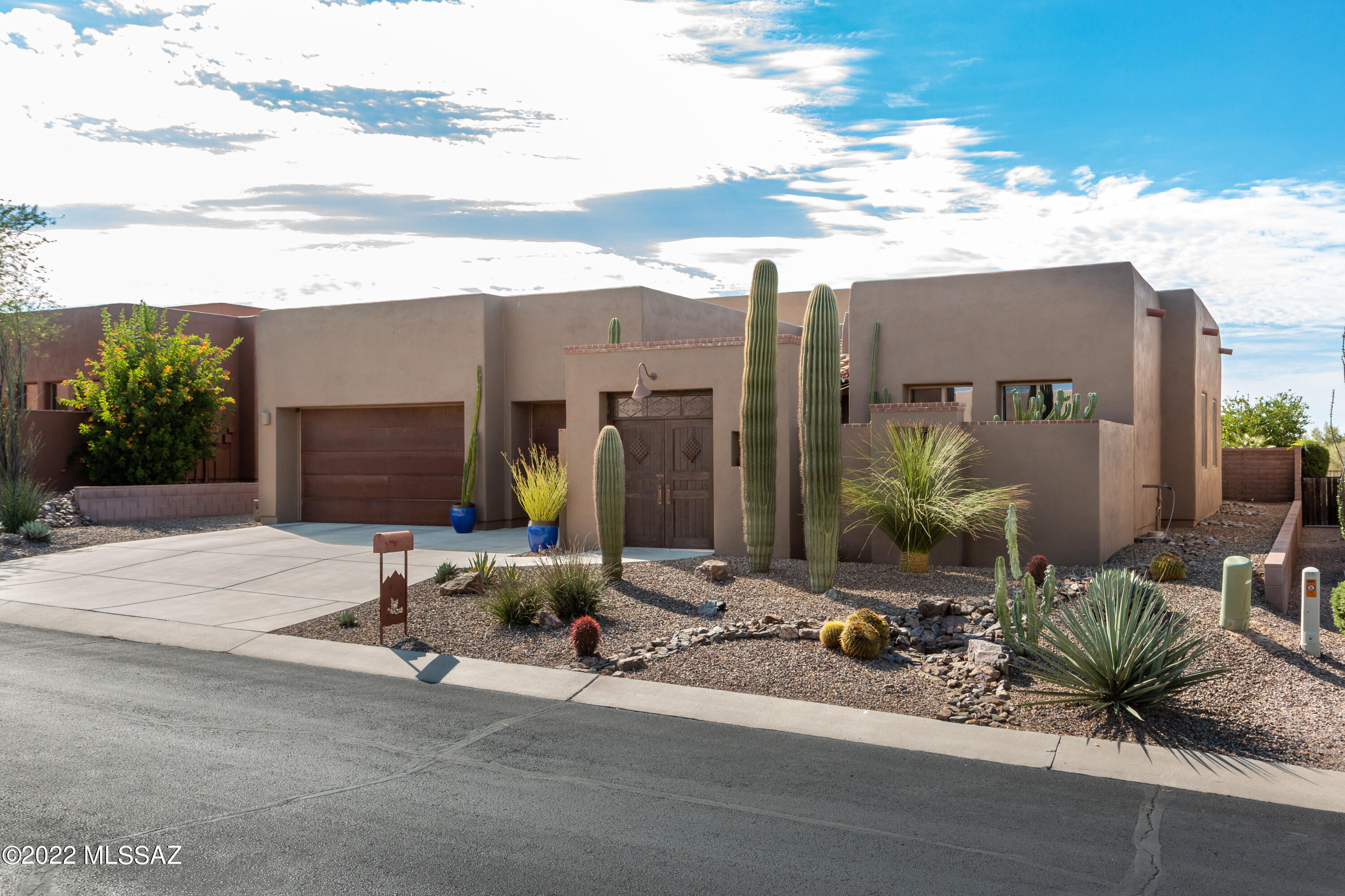 Spectacular Semi-Custom, INSIGHT home in gated Preserve II at Dove Mtn boasts upgraded amenities and luxury living. Desirable 2,675 sq.ft. Falcon plan offers 4BD, 2 full baths, 3 car garage and panoramic views of Catalina/Pusch Ridge and Tucson/Sombrero Peak Mtns.  Front yard saguaro's invite you to drive up to the triple garage w/rustic metal doors, followed by a gated courtyard entrance to this wonderful home.  Inviting foyer flows into living-dining room w/soaring 15'' high wood beam ceiling, upgraded tiled floors throughout along with the large master bath shower/counter.  Spacious ensuite leading to covered patio.  A Bose surround system exists for the living room and back patio for enjoyment! The kitchen is a chef's delight with all SS appliances, granite countertops, convection oven w/bar seating and cherry cabinets.  Beyond lies a living-dining room w/kiva FP.  The resort style backyard has unobstructed open space with custom self-cleaning pebble tech heated pool, spa, fire-pit and gas grill/island for ultimate entertaining.   Existing roof coating warrantied through 3/2023 and house exterior recently painted in 2020.