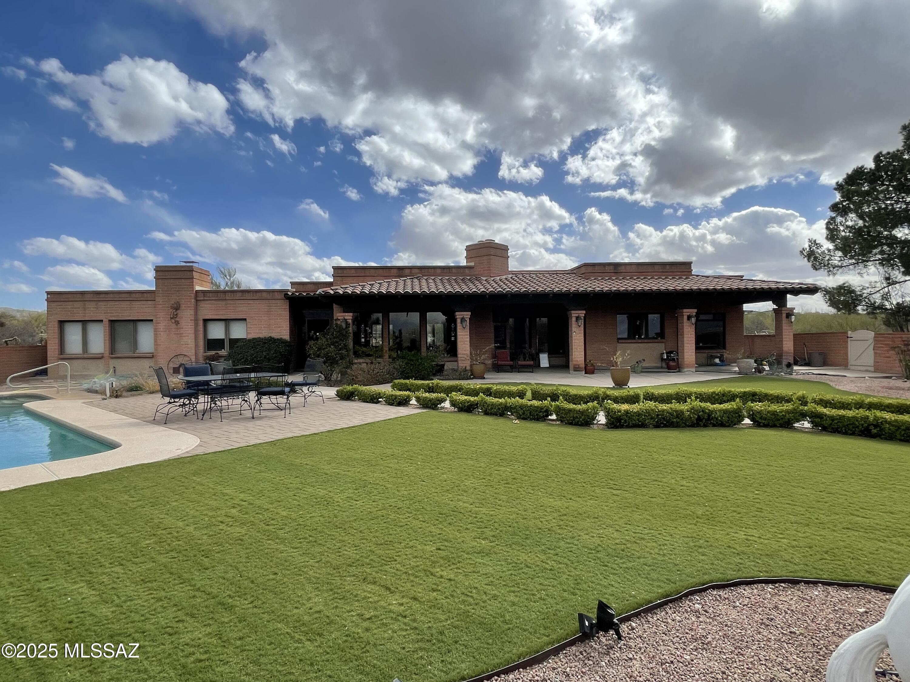 ***BACK ON THE MARKET***. This north facing home with stunning views of the Catalina Mountains awaits you, This 3 bedroom, 2 1/2 bath with a hobby room boasts 2592 square feet, a 2 car garage with plenty of additional parking on the west and south side. Large 6''x8'' beams accent the living room, family room and the dining room. The primary suite equally offers outstanding views of the Catalina Mountains. There is an adjoining bedroom connecting to the primary suite with a passthrough fireplace. Another bedroom is oversized with it's own ensuite located across from the kitchen. The hobby room contains a closet, possibly to be used as another bedroom. A large corral is located behind the home which can accommodate 3 horses.