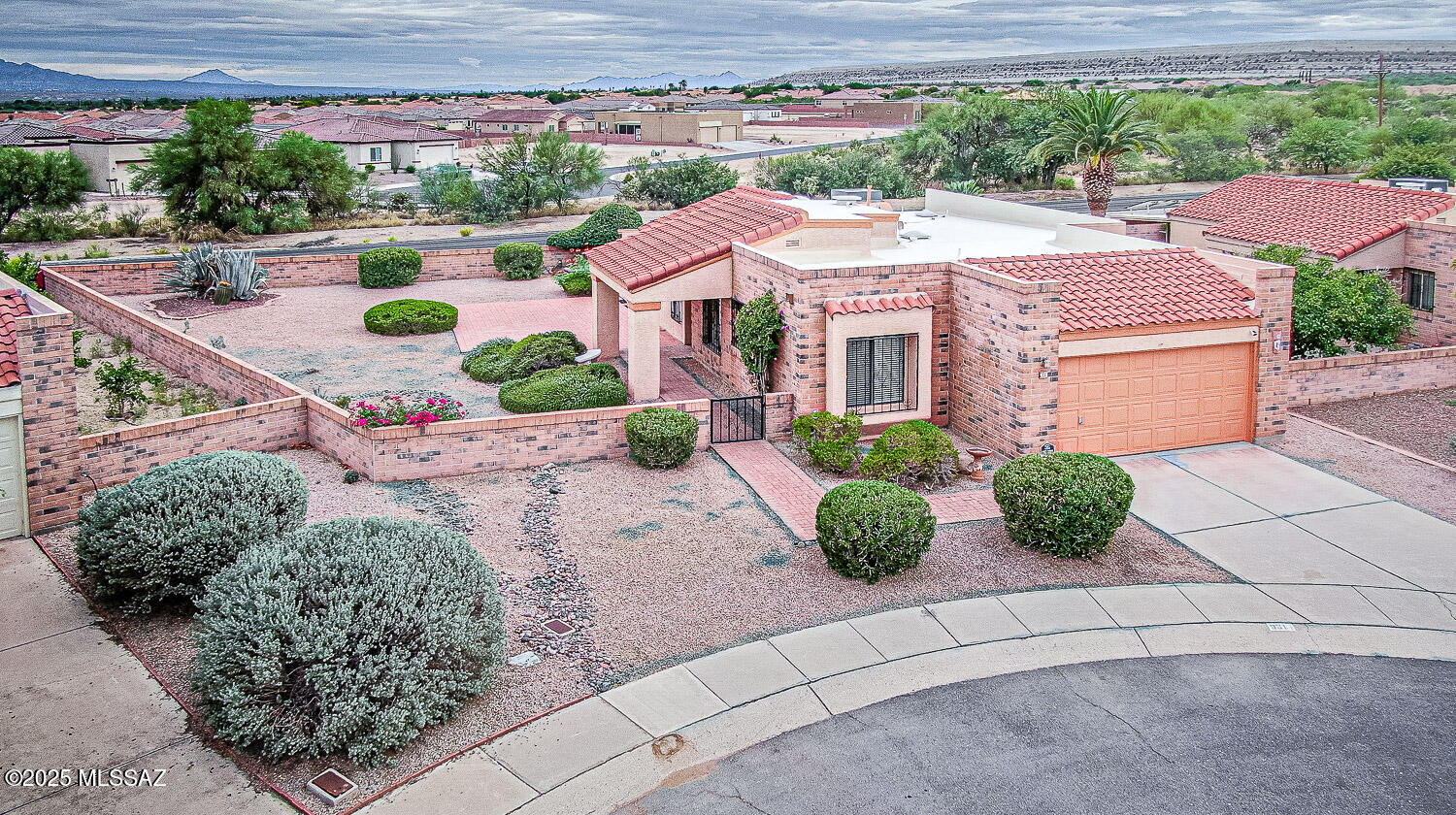 Discover and experience a quiet and peaceful neighborhood with a blend of southwestern charm and spectacular views of the Santa Rita Mountains.  
This home boasts a generous yard with a waterfall feature and a backyard patio with several large paver covered areas that look out right at the mountains.
This home has been recently updated with LVP flooring throughout, freshly painted inside and out, new light fixtures and ceiling fans and window treatments.  Brand new Tankless Instant Hot Water System was also recently installed.  All new electrical outlets, switches, new satin nickel hinges, door handles and shut off valves in the bathrooms.
This home's interior boasts high vaulted ceilings in the living area and skylights in both bathrooms as well as the living room. This home also includes an oversized garage with a spacious work area.
The kitchen boasts a front view breakfast nook and a dining area view of the Santa Rita Mountains.
Enjoy complete access to all areas of Green Valley, including shopping, golf courses, hiking trails and restaurants