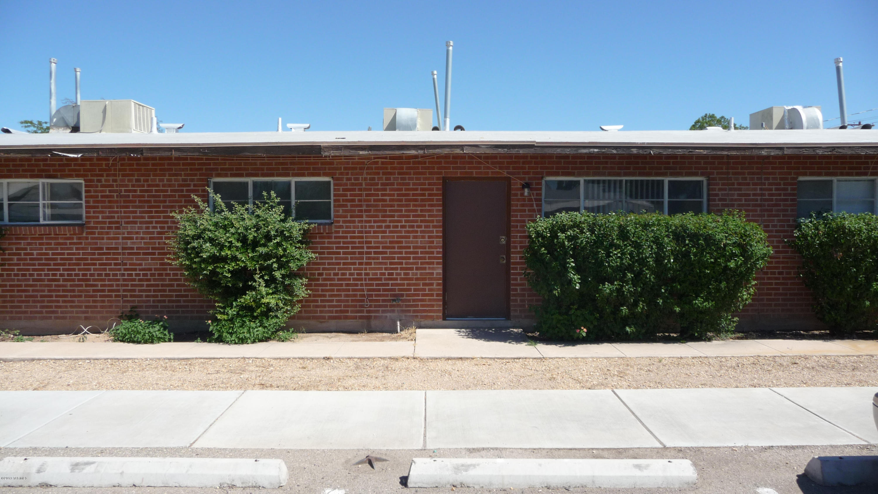 Spacious unit of triplex with off street parking and fenced yard! Wire cut brick construction with open and cheery floor plan! Ceramic tile throughout. Gas heat and H/W, evap cooled for efficiency! Appealing, convenient location at an affordable price! Close to bus lines, schools and shopping, and just 3 miles from U of A!