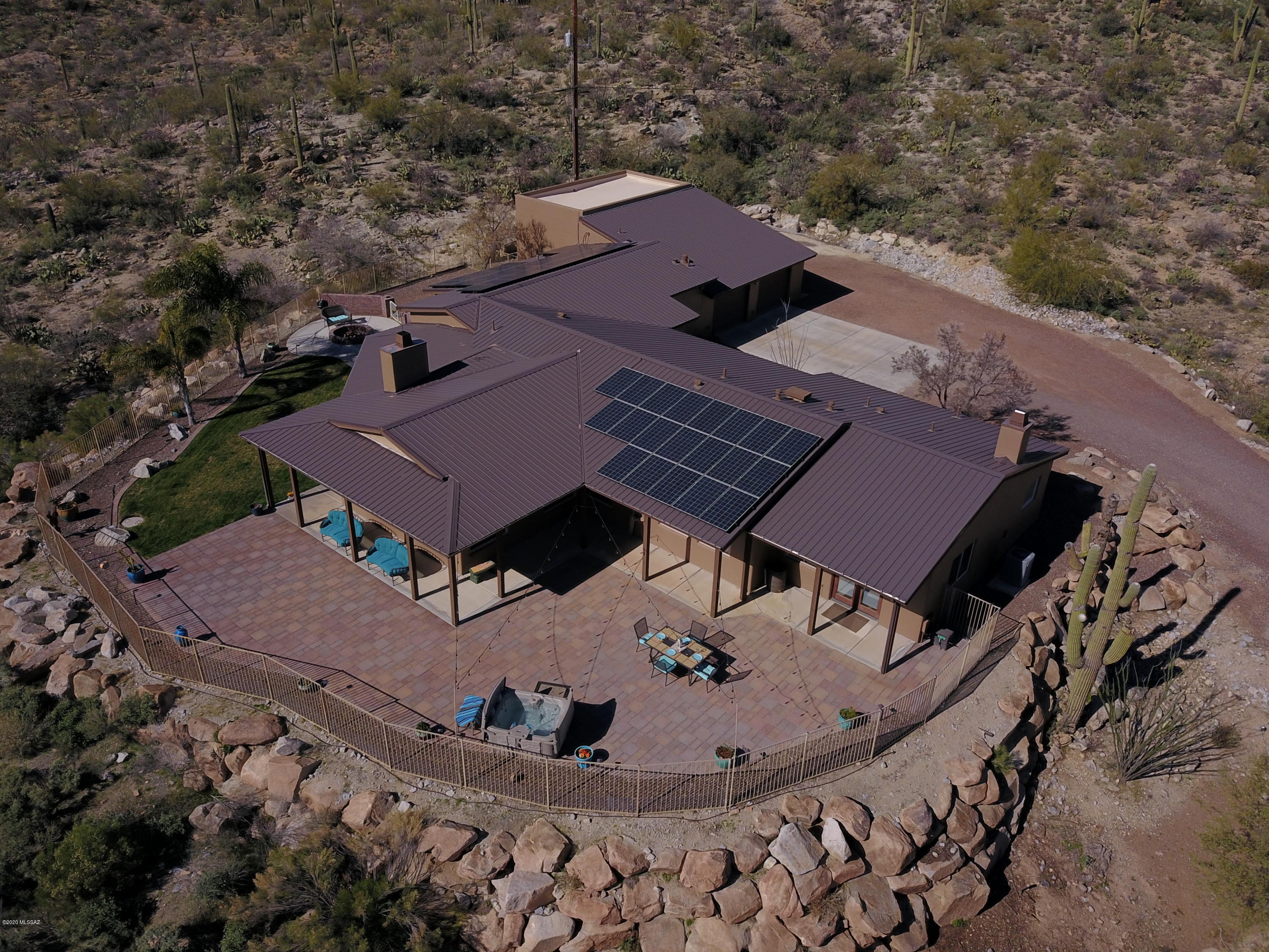 Welcome to your private luxury Tucson ranch!  This home site boasts panoramic mountain views & 3.62 acres of desert paradise for all the privacy you want.  3010 sq ft of living space w/ 4 bedrooms & 3.5 bathrooms.  Open great room concept w/ built in surround sound speakers perfect for entertaining.  Kitchen includes 2019 GE stainless steel appliances, alder cabinets, & walk in pantry. Both dining room & master bedroom have fireplaces.  There is a Home Automation & Security System installed. Large master suite complete w/ mountain views, a master bath w/ his & hers vanities, garden tub, & walk in shower.  Back yard is perfect for entertaining w/ a large covered porch area/patio, outdoor speakers, fire pit, separate dog run.  2 car garage w/ an RV Garage w/ surround sound speakers. Must see
