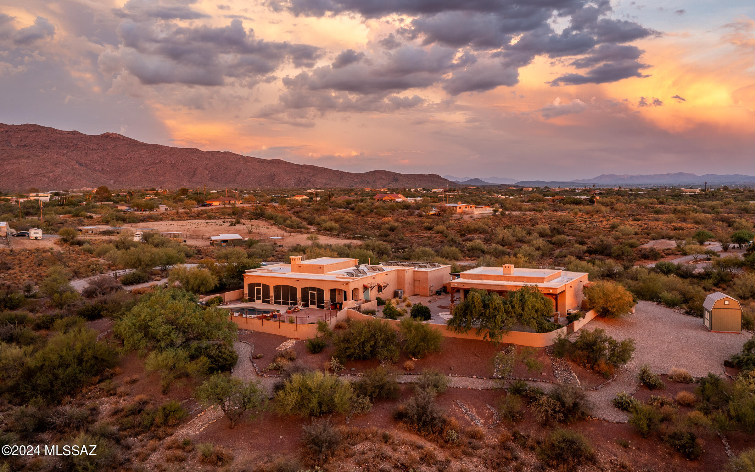 Seller is offering 3-2-1 or 2-1 interest rate buydown with accepted full price offer.  Nestled on 3.73 acres, in the heart of Tucson, this stunning estate, crafted by builder Buddy Greer, epitomizes luxury with panoramic 360-degree mountain views. The main home welcomes you through a gated courtyard into a sophisticated open-concept layout, where rustic hand-carved wood beams and a stacked stone fireplace create timeless charm.  The kitchen has granite counters and stainless-steel appliances.  The back patio has been converted into a full-length Arizona room.  A perfect extension for entertaining.  The generous three-car garage provides ample space for vehicles and storage.  Solar is paid off.

The exquisite 1,102 sq. ft. detached guest house, featuring awe-inspiring mountain views. Perfectly designed for guests or as a private retreat, this luxurious space offers a welcoming ambiance with a cozy stacked stone fireplace at its heart.  Relax and unwind in the generously sized bedroom, complemented by a bathroom with a luxurious soaking tub for ultimate relaxation. Additional features include ample extra storage, ensuring that every need is met. With its serene surroundings and thoughtful design, this guest house combines comfort, convenience, and natural beauty.

Outside, the meticulously landscaped grounds offer multiple outdoor living areas, ideal for al fresco dining, lounging by the pool, or simply soaking in the serene vistas.