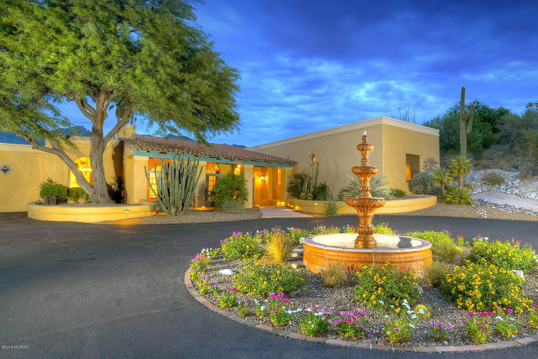 Perfectly situated on a private elevated lot, this fabulous Cat 10 Mediterranean Style home captures the expansive Catalina Mountain Views & Sparkling City Lights. Gallery style foyer welcomes you into this tasteful home. Multiple windows & french doors allow abundance of light to fill these generous rooms. Stunning interior design includes Sandstone flooring, dramatic Cantera fireplace, exposed beam ceiling & claw foot tub. Gourmet kitchen features high end appliances, 6 burner Viking range, double ovens, over-sized island & Sub Zero. Redesigned spacious Master suite includes glass enclosed shower, double vanities & large walk in closet, and cozy FP. Guests/teens will enjoy their own quarters which include 1 bed & separate living/kitchen area. Lush back yard with pool, spa & ramada.
