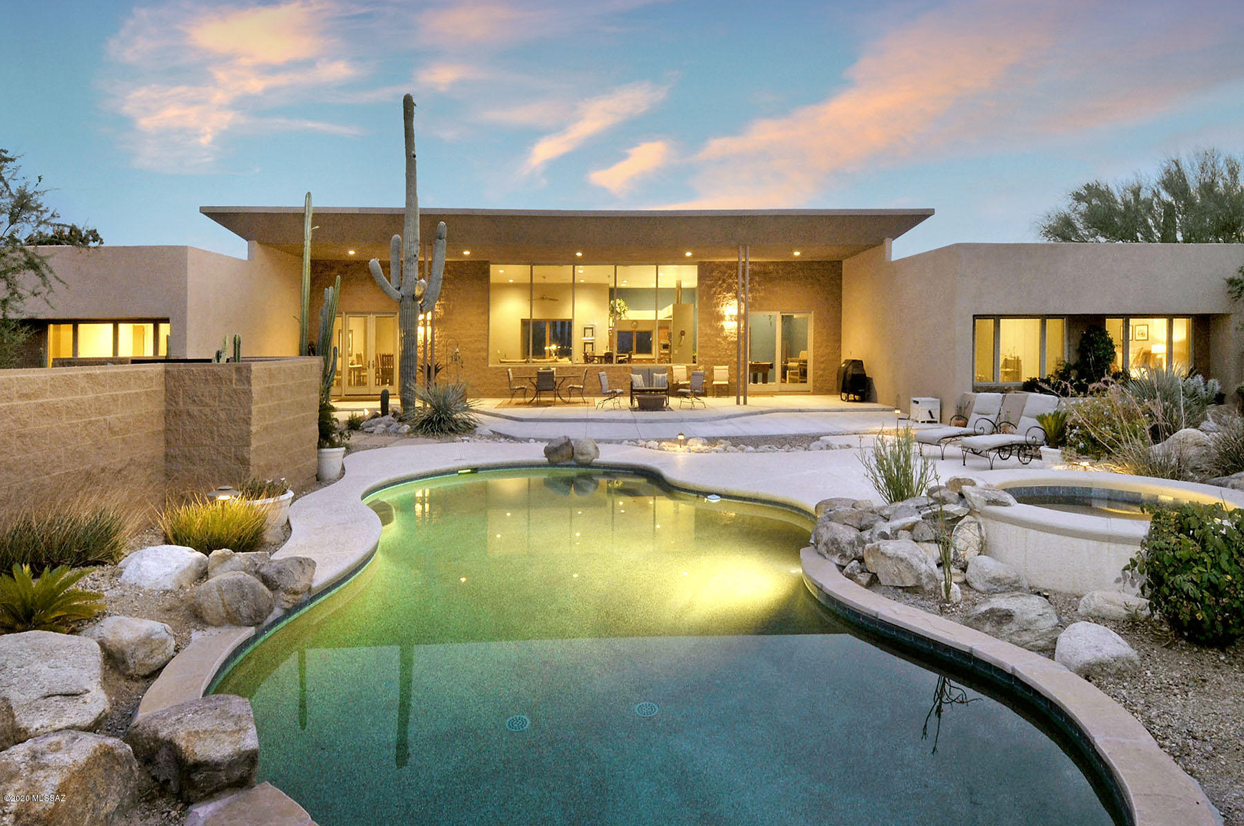 Dramatic pure contemporary with Breathtaking mountain views in prestigious gated Pima Canyon . Designed by architect Frank Mascia, this exceptional home captures views from every room featuring an open floor plan with exquisite Greatroom , 12 ft. high floor to ceiling windows, formal dining room, gourmet kitchen w/granite countertops,  stainless steel appliances, 6 burner gas range , SubZero, breakfast bar, cozy den/library,  polished concrete floors throughout, 3 bedrooms plus study, 3 1/2 baths, laundry room and 3 car garage. Enjoy gracious award winning outdoor living designed by Lori Carroll w/covered patio, lagoon style pool and spa, built in  BBQ, gas fire pit,incredible garden of sahuaro and other beautiful cactus specimens, end of cul- de -sac w/magnificent mountain views.