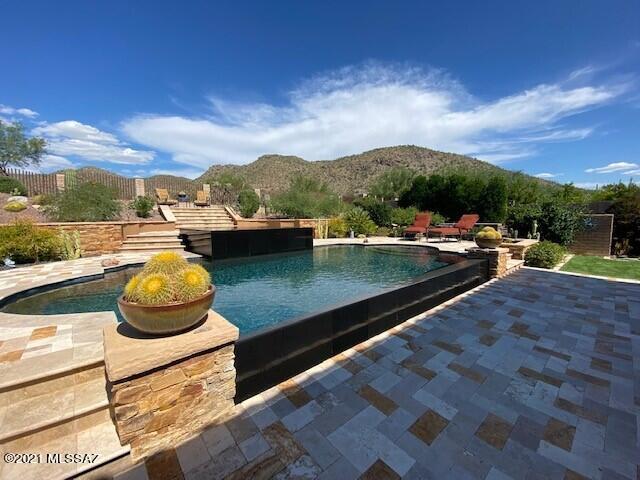 * DESERT ELEGANCE*- STUNNING TOLL BROS ESTATE BORDERS ''THE GALLERY'' NORTH COURSE...INCREDIBLE MTN VIEWS SOARING SAGUAROS, ROCK OUTCROPPINGS...PERFECT SETTING! GORGEOUS BKYD PARADISE... FEELS LIKE  A RESORT! MAGNIFICENT HEATED ''REVERSE NEGATIVE EDGE'' POOL- DRAMATIC BLACK INFINITY POOL & SPA, TIERED TRAVERTINE PAVED LOUNGE AREAS, RAISED PLANTERS FILLED W/BRILLIANT FLOWERS- UNIQUE DESERT CACTI/TREES! FULL COV'D PAVED PATIO , TURF FOR THE PUPS...TRULY A DREAM COME TRUE! TONS OF UPGRADES- ''BRAND NEW'' PRIMARY BATH- FREE STANDING TUB, GLASS SHOWER, 4 BR EN- SUITES, BONUS ''FLEX/GAME ROOM + LIBRARY/OFFICE! WELCOMING COURTYARD W/FP, HUGE GREAT RM, WET BAR, WALL OF GLASS TO VIEWS, GOURMET KIT- INCLS  UPGRADED SS APPLIC/W&D , OVERSIZED CUSTOM ISLAND, 2 STONE FP! HOME HAS BEEN LOVED & CARED FOR!