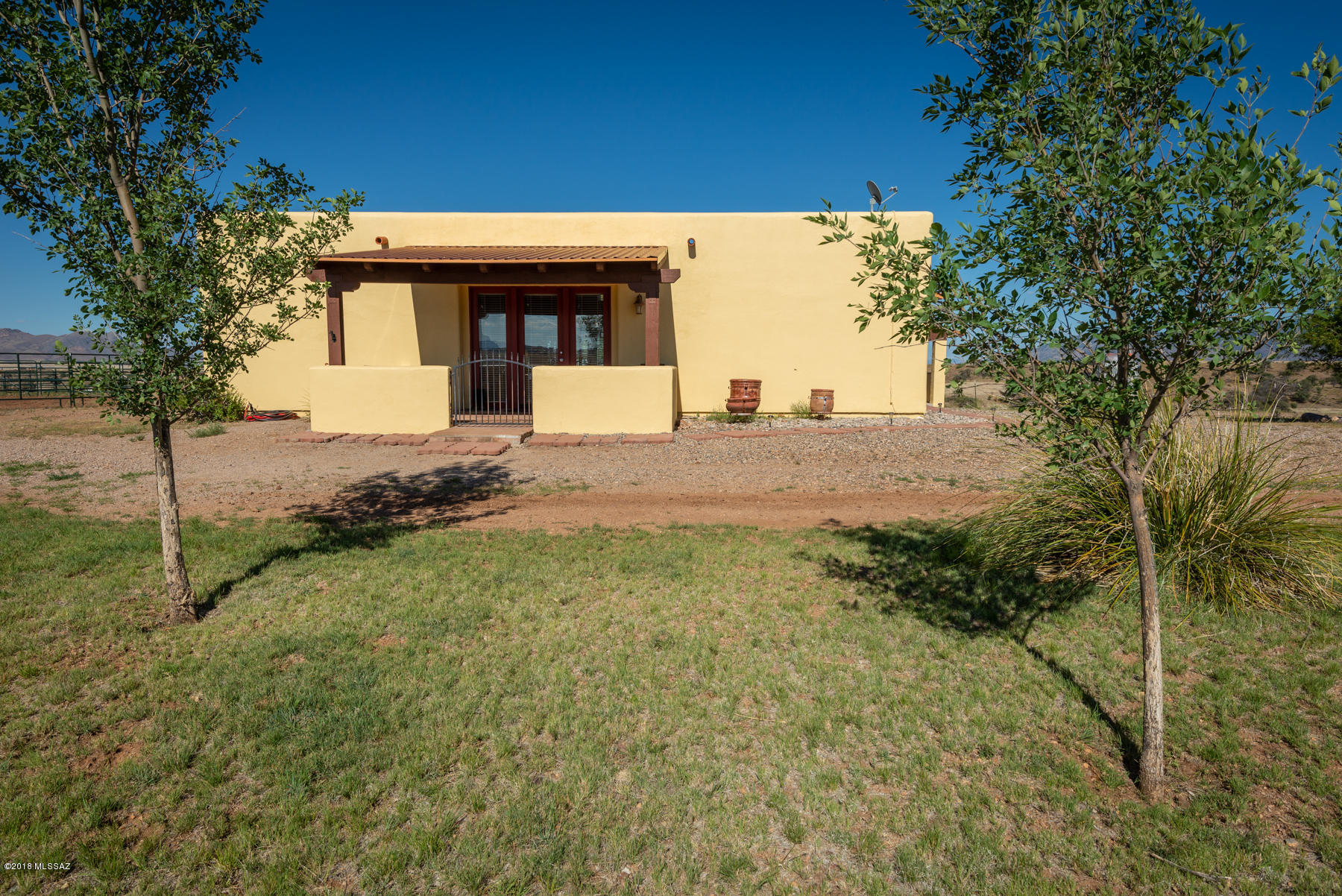 Big sky hilltop charming home with TOP OF THE WORLD panoramic views! Highly desirable location with end of road privacy. Nicely landscaped walled courtyard with views of the Mustangs, Whetstones and Huachuca Mtns. To the south this property overlooks a private ranch that leads to national forest nearby. (poss. ride-out on ranch with permission) Amazing horse facilities! Very spacious great room and kitchen with high ceilings. Beautiful natural stone adds rustic touch surrounding Jotul cast iron gas stove in great room. Extensive Arizona Room runs full length of home. Great for entertaining your guests!  Handsome rough cut wood beams accent doorways, Saltillo Tile flooring throughout, custom tile countertops, in the heart of Elgin Wine Country and nearby Parker Canyon Lake!  A must see home