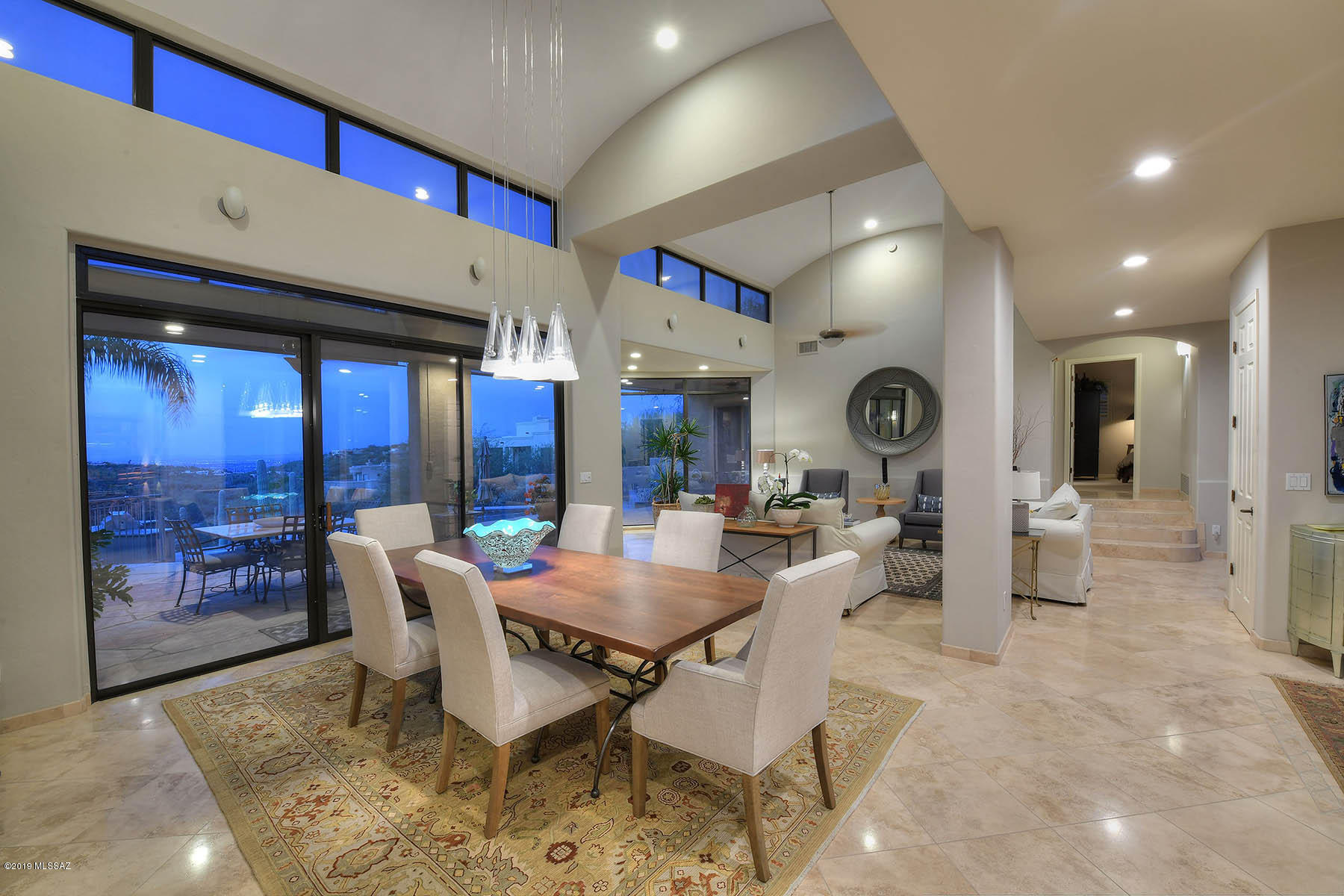 Outstanding Alta Vista Contemporary designed by Bill Gansline with dramatic views.  Located on a cul-de-sac backing up to common area desert, this light and airy 4,101 sq. ft., 4 bedroom plus den/office (could be 5th bedroom) offers all living areas on 1st floor with garage and 1 bedroom downstairs.  Enter into stunning living/dining room with soaring architecturally designed ceilings, walls of windows, clerestory windows, city and mountain views.  Travertine stone, ceramic tile and wood laminate floors, plantation shutters and custom wood blinds throughout.  Remodeled gourmet kitchen features stainless steel appliances, Viking cooktop, oversized center island/breakfast bar and adjacent family room with stacked stone fireplace.  Remodeled baths throughout, gracious master suite, including garden tub, walk-in closet, walk-in shower and dual vanities.  Expansive rear covered patio has flagstone floors, BBQ, pool/spa and city views make this a must see property.