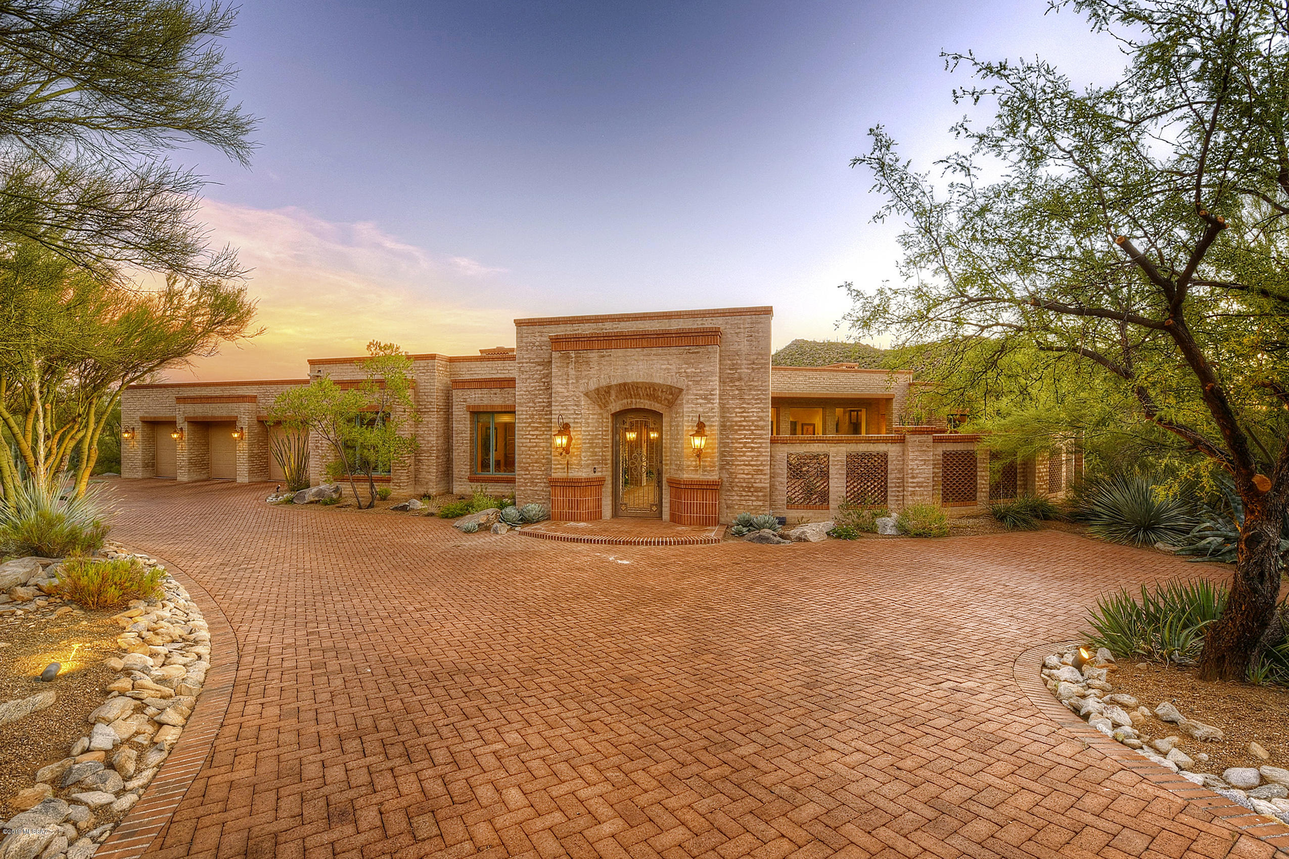 *TUCSON JEWEL* STUNNING ESTATE BOASTS THE ESSENCE OF CLASSIC SW DESIGN...THIS TERRITORIAL OFFERS THE BLEND OF HISTORIC TRADITIONAL FINISHES & TODAY'S ELEGANT ARCHITECTURE & APPOINTMENTS! NESTLED ON OVER ACRE SURROUNDED BY SONORAN DESERT, PANORAMIC MTN VIEWS IN EVERY DIRECTION & DAZZLING CITY LIGHTS! TUCKED ON CUL DE SAC LOT-ENTER  PAVED MOTOR COURT/DRIVEWAY TO  WELCOMING COURTYARD, QUALITY AT ITS BEST! SOARING BEAMED CEILINGS, FLOOR/CEILING PELLA WINDOWS EMBRACE THE GATHERING RM, BUILT IN MEDIA CAB/SOLID MASONRY HOME & FIREPLACES! STONE FLOORS THRU-OUT, 8 FT WOOD DOORS, DREAM KIT, GUEST WING OFFERS 2 BR/EN-SUITES, SPLIT PLAN, MSTR RETREAT- ROMANTIC FP, GLAMOROUS SPA BA, PATIOS/ VERANDAS WRAP HOME! ENJOY LIFE ON DOVE MTN- GALLERY CLUB/FITNESS, CLUB @ DOVE MTN, HIKING/BIKING TRAILS GALORE!