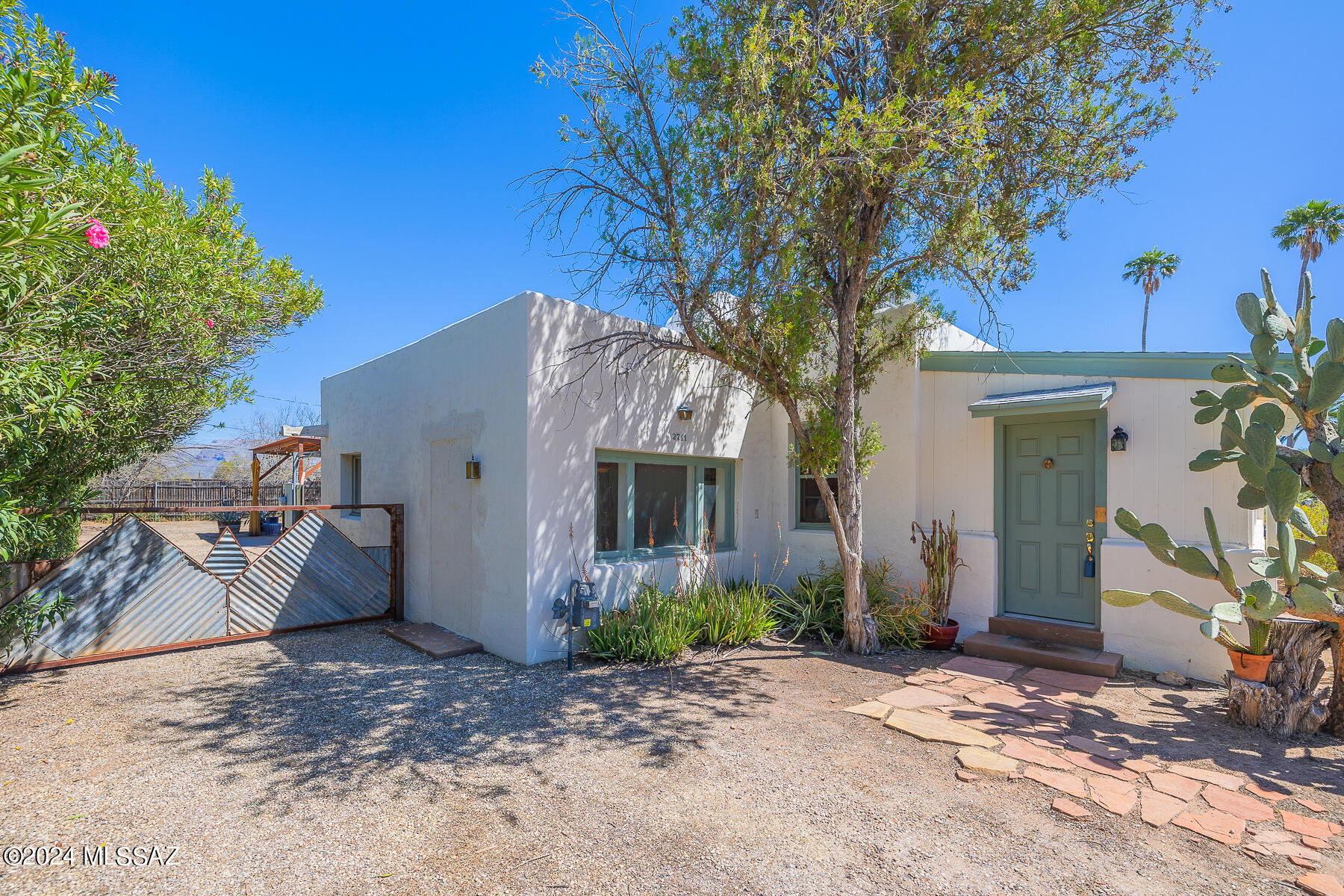 Welcome to this charming updated 2BR Mud Adobe home located in the in the heart of the Historic Blenman-Elm neighborhood! Featuring beautiful hard wood and colored concrete floors. Updated kitchen with custom cabinetry and Quartz counter tops. Updated bathroom. Living room with cozy fireplace and wood floors. Spacious family room with colored concrete floors., Spacious bedroom with sliding barn doors. Large private walled rear yard complete w/gazebo & free standing workshop/storage building. Updated Trane HVAC unit.  The large 12,000 sqft lot offer endless opportunities. Wonderful location only minutes from the University of Arizona, Banner Hospital, downtown, public transportation, parks, shopping & dining. See agent only remarks.