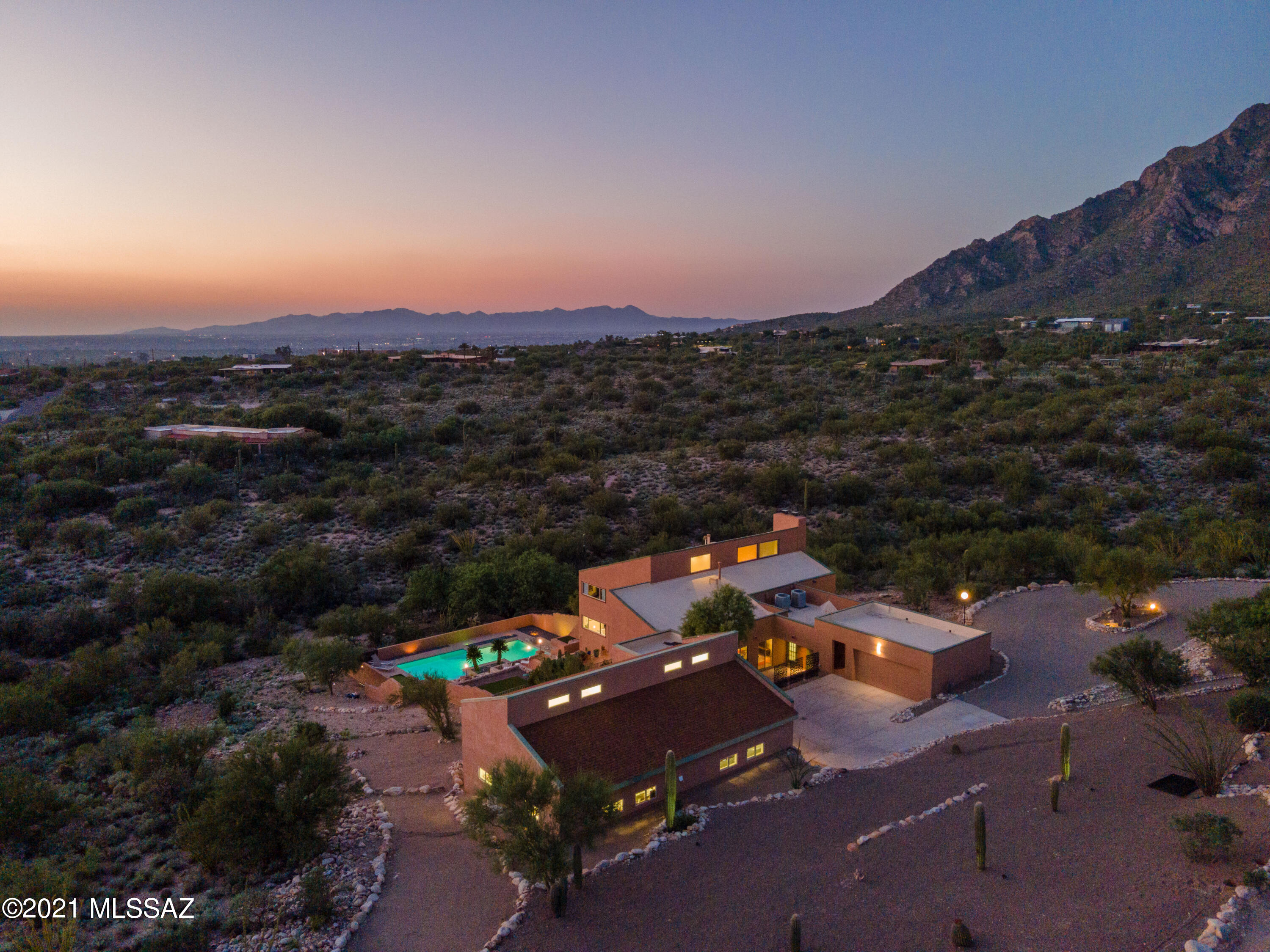 Range pricing $1,295,000-$1,350,000. Captivating 6+ acre contemporary Cobo Catalina Mid-century design by renowned architect Robert Swaim boasts floor to ceiling windows complemented by a flowing open floorplan w/ 360 degree views of Pusch Ridge, Pima Canyon & the Tucson Mountains. 2021 remodel includes a complete luxury kitchen outfitted w/ professional grade appliances wrapped in beautiful high movement granite. Modern terrazzo porcelain tile & refinished hardwood floors throughout. Walk outside to a new landscaped terraced pool leading to a cantilevered deck w/ unobstructed vistas & spectacular city lights. Step into a separate 1,408 Sq. Ft. temperature controlled 4 bay/RV garage+workshop w/ lift height ceilings. Expansive bonus studio holds a full gym. A complete Foothills Estate!