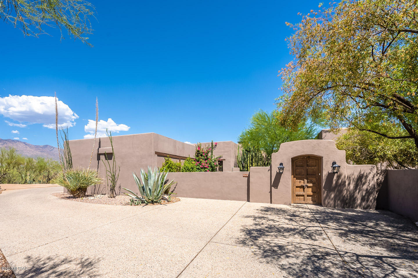 Wide open stunning views surround this immaculate, authentic 1938 Joesler. Perfectly blended luxurious, master suite addition by Tyson w/ fireplace & private patio. Meticulously restored throughout. Plaster walls, original hardware, doors, concrete & tile floors plus amazing hand forged light fixtures & hand-painted tiles by artist Ysauro Uriarte. Large picture windows frame desert, city & mountain views.  Gracious ambiance connects home with nature in private, tucked away setting. Beautiful new soapstone counters overlooks charming kitchen patio & BBQ area. Courtyard entry with desert garden & mature specimen cactus. Peaceful & secluded pool area with fireplace. Steps lead to greenhouse, continue on to access wash & miles of walking trails. Studio could be converted back to 3rd car garage