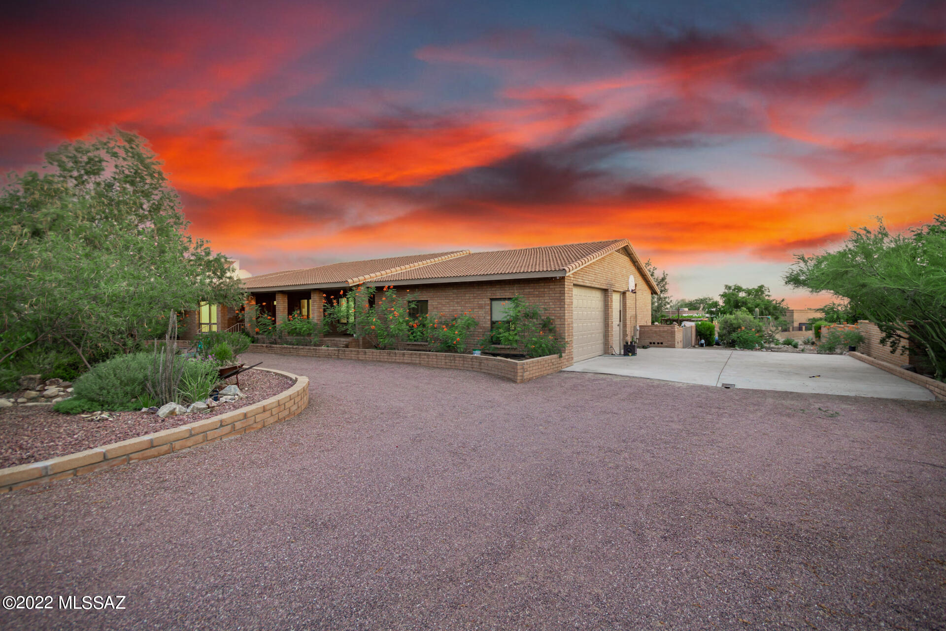 Rare opportunity in highly coveted Shadow Hills neighborhood, situated on more than half an acre within the Catalina Foothills school district. Presented by the original owners, this sprawling home features separate recessed living and family rooms, 4 bedrooms, 2 baths, a 9ft clearance 3 car garage (large enough for some recreational toys). Enjoy an additional 256 sq ft workshop not included in the main home square footage, accessible through the garage or backyard. Retreat to the stunning backyard, which boasts a sparkling pebble tec pool and 3 waterfall features, refinished in 2015, 16'x12' ramada, mature landscaping to include fruit trees, and a garden in the corner. Enjoy low utilities bills in the winter months, as the exclusive 1986 WELLS fireplace is sufficient to heat the entire Roof replaced in 2017, windows all replaced in 2018, and special edition central vac installed 2018. Circular drive, additional concrete pad, and large garage provide plenty of parking. Full list of upgrades can be found in documents section. Make this your own desert oasis!