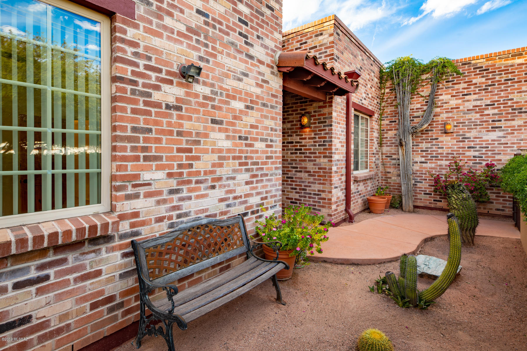 Inspired by the famed architecture of Josias Joesler! 1-Owner Luxury Residence on 1/3 acre was built in 2006. It matches & celebrates the grand history that surrounds it! A True Foyer w/Tray Ceiling & Tile Medallion! 11ft ceilings in the Great Room. Wood clad patio doors open to the pool area! The pool is surfaced w/amazing cobalt blue mosaic tile! Gas Kiva Fireplace! All floors are TILE! The island kitchen is to die for! Knotty Alder & Granite Slab. Playful Talavera Bath Sinks! Abundant Modern conveniences that can ONLY be found in a recently built home! 4 Water harvesting cisterns! Insulation, zoned HVAC!!! Charming 1BR/1Ba Guest House w/sep. electric service. Alley behind can be used for rear access. Truck-sized double garage & sep workshop/shed. Walk to restaurants & bike to U of A!
