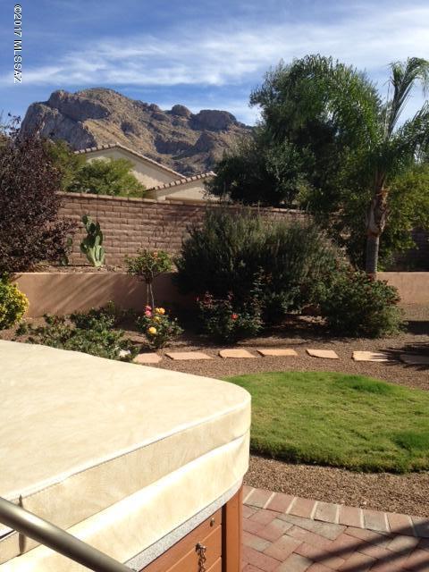 Move in ready home with east facing mountain views. Zen like backyard with kiva fireplace, outdoor kitchen, fountain, and extended patio cover. Interior finishes include granite counter tops, stainless appliances, wine cooler, built in desk and serving buffet. Oversized tile and Pergo X-tra Performance flooring. Back bedroom has carpet. Custom paint finishes, pull outs in cabinetry, and California Closet in MBD. One bedroom has built in desks, shelves and drawers. This home is tricked out and ready for you to move in!