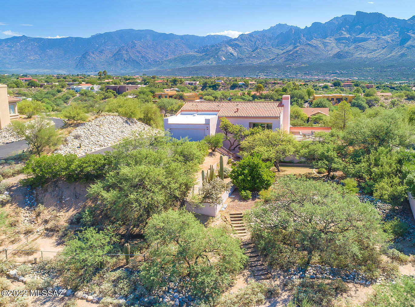 Spectacular custom home with pool set back on a 1.25-acre hilltop lot boasts breathtaking, unobstructed mountain views. Main level hosts formal living room w/soaring beam ceiling, striking FP & dual view decks. Dining room has wood floors & recessed octagonal ceiling. Kitchen offers granite counters, back splash, island & dining nook. Lower level has central Family room w/wood plank & beam ceiling, hardwood floors, brick wall FP, full bar, dual patios. Owner's suite w/vaulted ceiling and library/office hosts bath w/jetted tub & walk-in shower. 3 additional bedrooms + hall bath. Main patio leads to private pool & spa w/ mountain views. Large yard. New powder room, sliding patio doors w/sunshades, Trex decking, ceramic plank tile, water heaters, Lennox HVAC (2012), tile roof (2011). Views!