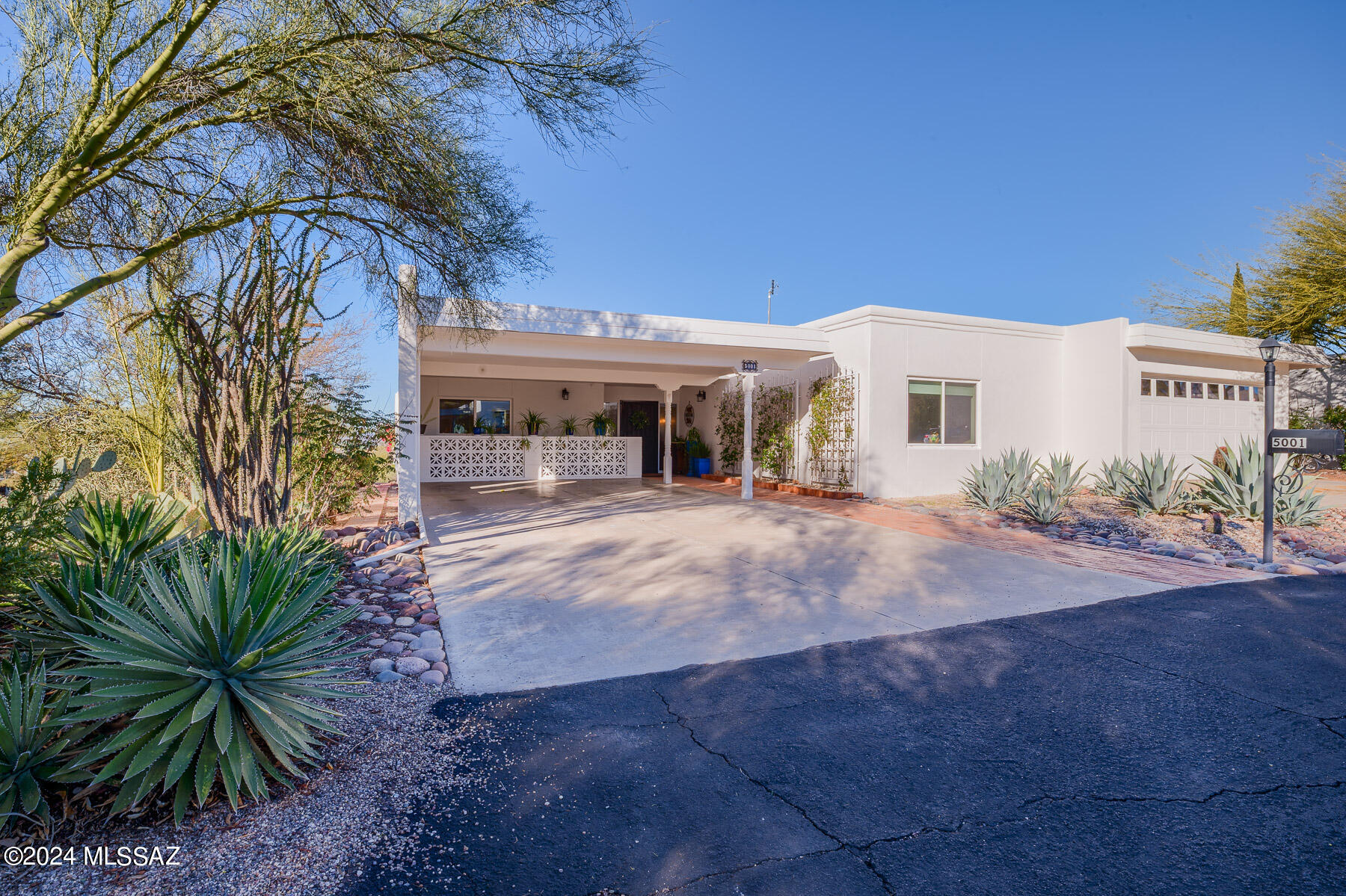 Pride of ownership is evident throughout this end unit townhome with majestic sunset views over the Tucson Mountains and city from the elevated hillside lot.  Once you enter it will be evident that the owners have tastefully updated and maintained the property throughout the years.  Sunset views can be seen from the great room, kitchen, & dining area as well as the temperature controlled Arizona Room. The patio will become an extension of the interior as it provides plenty of space to relax and the best views on the property.  2 bedrooms + den/office, 2 bathrooms, 2 car carport, and oversized laundry room with space for freezer or storage finish out the home.  The community pool is located just down the street.  This is a 55+ age restricted community.