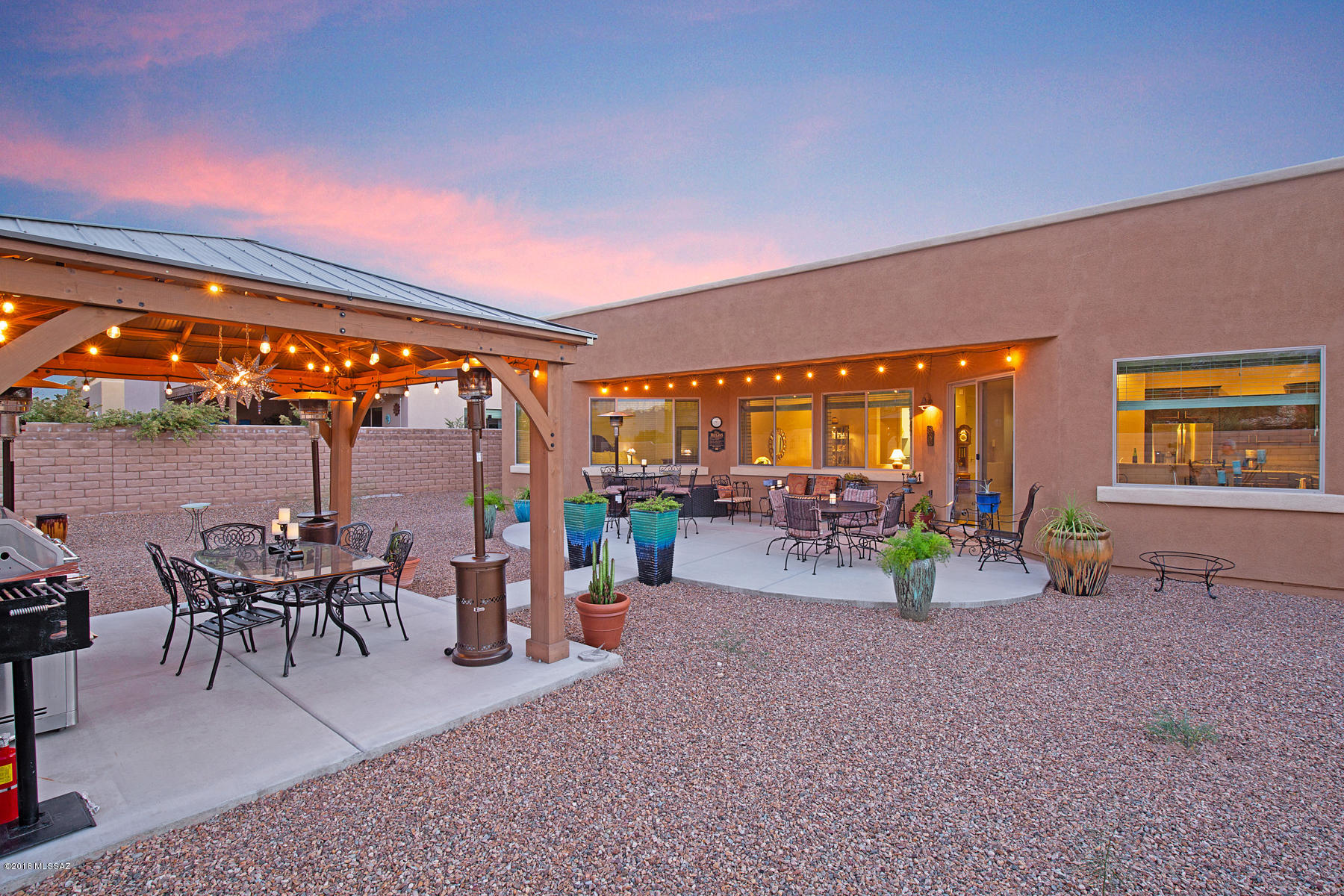 Custom 2016 Built Mesquite Beauty located on the desirable North East Side of Tucson. Original model home with full upgrades: Granite Kitchen Counter Tops, 42'' High Cabinets with Crown Molding, Raised Bar Top, Bonus Room that can be Dining or a Den, and Wood Plank Built Ramada on your extended patio. This Territorial house is designed for Solar and has Smart Features, Easy Care Landscaping with Drip Irrigation, and a 3 car Garage.  Enjoy the views and entertain in your new place!