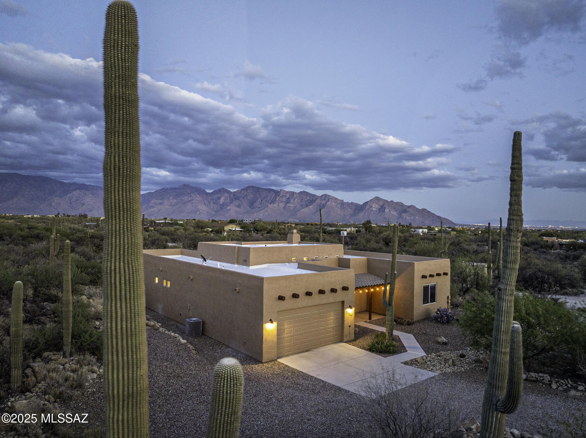 Discover this stunning, custom-built Santa Fe style home nestled on 2.42 acres of pristine, Saguaro-studded desert—offering the perfect blend of Southwest charm and modern comfort. From the moment you enter, you're welcomed by a spacious open-concept great room with soaring 12-foot viga beam ceilings and a striking stacked stone fireplace that anchors the space beautifully. Large windows bathe the home in natural light, highlighting the polished and sealed stained concrete floors in the main living areas. The kitchen features rich hickory cabinetry, slab granite countertops, and Slate appliances—ideal for everyday living and entertaining alike. Designed for today's living with a desirable split-bedroom floorplan for privacy, plus two versatile flex rooms perfect for a home office, den, or creative studio. Step outside to your own desert oasis: an expansive, deep-covered patio facing east to capture spectacular Catalina Mountain views. Enjoy your Pebble Tec pool, low-maintenance turf area, and plenty of space to entertain or relax under the stars. Additional highlights include:
"	Private registered well
"       50 Amp EV plug in garage 
"       Elevated view lot
"	Full sprinkler system
"	Winding manicured walking trail with scenic seating areas
"	Evening city light views
"	Adorable children's playhouse
"	Rustic henhouse with storage room, great for tack if you're bringing horses!
This one-of-a-kind property is well-maintained and move-in ready, a rare opportunity to own a private desert sanctuary that truly has it all.  Quality Constructions by Bednar Homes.