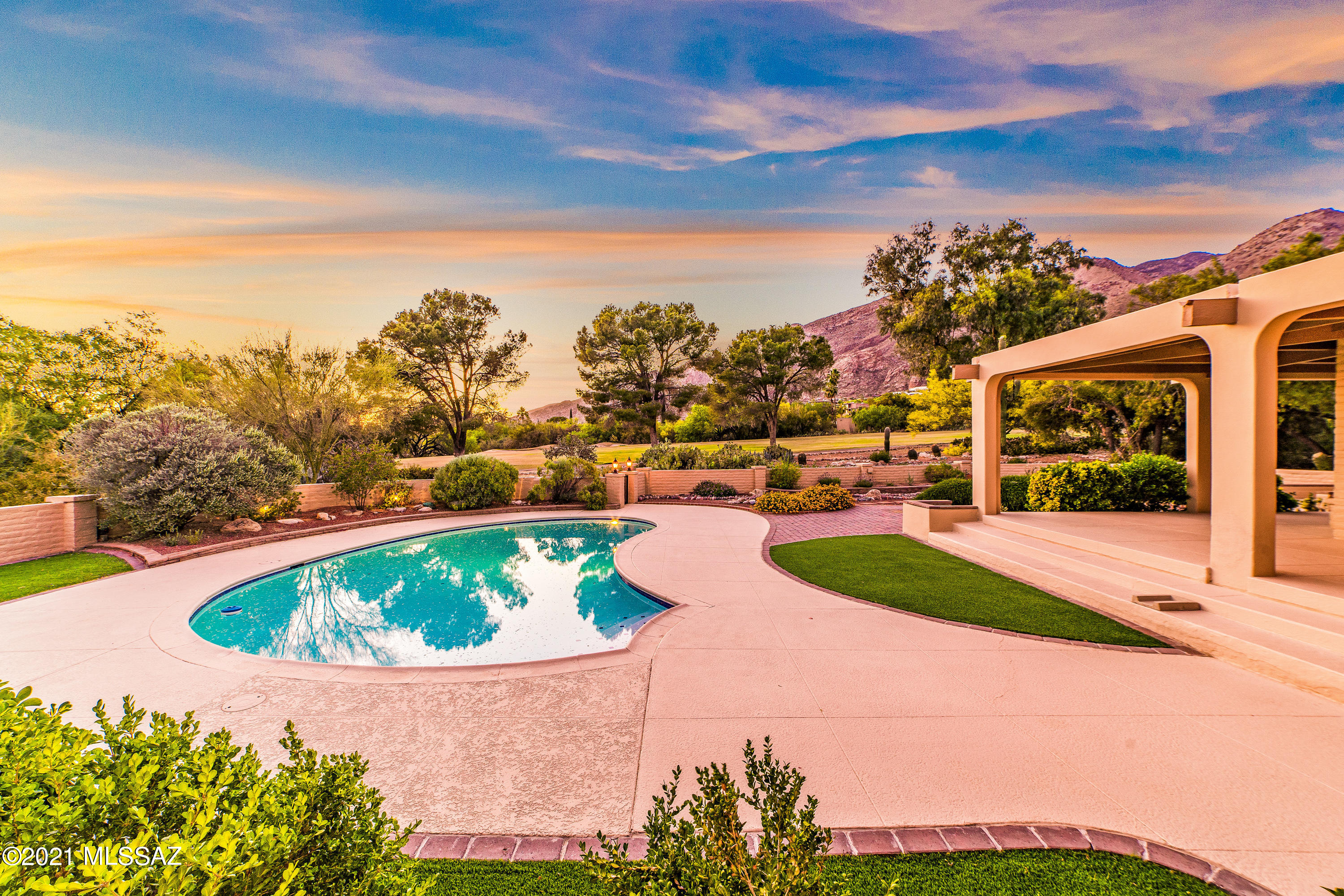 Splendid burnt adobe home and guest house in prestigious gated/guarded Skyline CC, designed by architect Jim Ware for his personal residence features stunning mountain & golf course views framed by abundant large windows and glass doors, rooms are awash with natural light, warm  bleached wood beamed ceilings rise above the bright, comfortable living room w/ cozy corner fireplace, comfortable family room off the kitchen boasts another fireplace; 3 beautiful bedrooms are all en-suite w/updated baths. Other features include gleaming saltillo tiled flooring,  newer windows & doors throughout, NEW AC, fresh paint; lovely paver circular driveway in front & in the pretty courtyard between the main residence and  guest house. Recently re-plastered pool with new pump & filter. Fantastic!