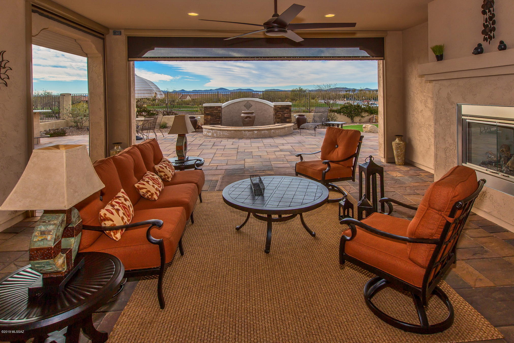 Panoramic mountain views and exquisite sunsets are yours in this beautiful Tesoro Model. Enter the front gate where your private courtyard awaits with entry to an inviting casita. Sit on the covered patio, warmed by a cozy fireplace , or fully shaded from the sun at the push of a button.  Relax and entertain at your built-in outdoor kitchen with pizza oven and griddle. Inside the home lovely wood grain tile floors add elegance and style throughout.  French doors provide privacy to the den. Beautiful tile backsplash adds to the gourmet kitchen and dry bar*Built in GE Monogram appliances*Range hood*Gas Cooktop* 3'' Plantation Shutters throughout* 5 ¼'' baseboards* soft-close drawers & pull-out base cabinet kitchen shelves *Large Laundry w/full cabinets*Garage w/built in cabinets*So much mor