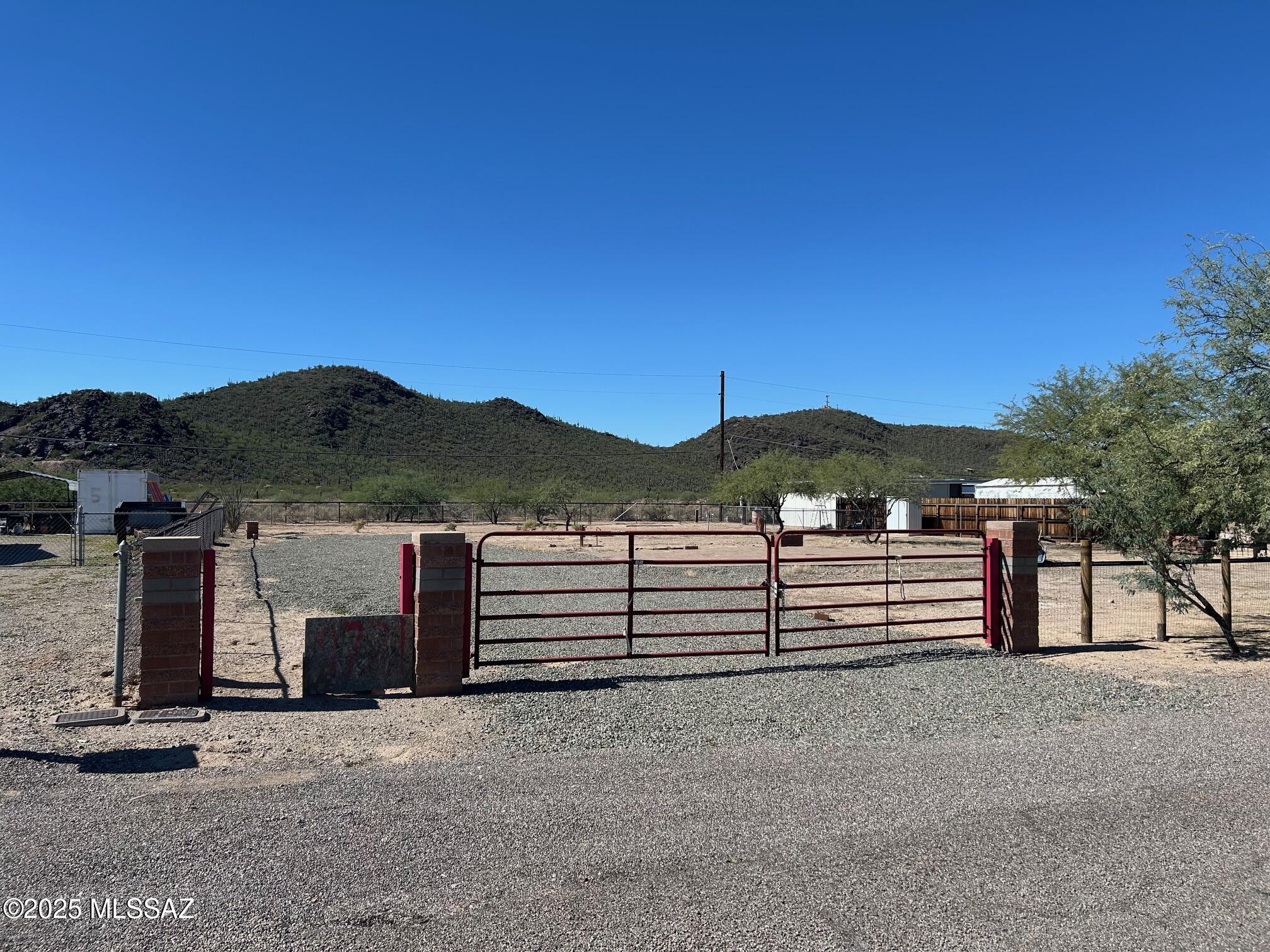 Prime,.37 acre. MANUFACTURED HOME LOT backing up to Los Monteros Conservation Area with stunning mountain views! This spacious lot offers privacy, convenience, and breathtaking scenery. All utilities are available, and property is fully fenced ready for your manufactured or site built home. Enjoy unobstructed panoramic views of the mountains to the west overlooking the serene Los Monteros Conservation Area while the Catalina Mountains rise dramatically to the east across a wide open, vacant area.  No HOA fees a plus! Located in a quiet, private neighborhood just minutes from shopping, dining, and easy access to I-10, this lot combines the best of natural beauty and urban convenience.