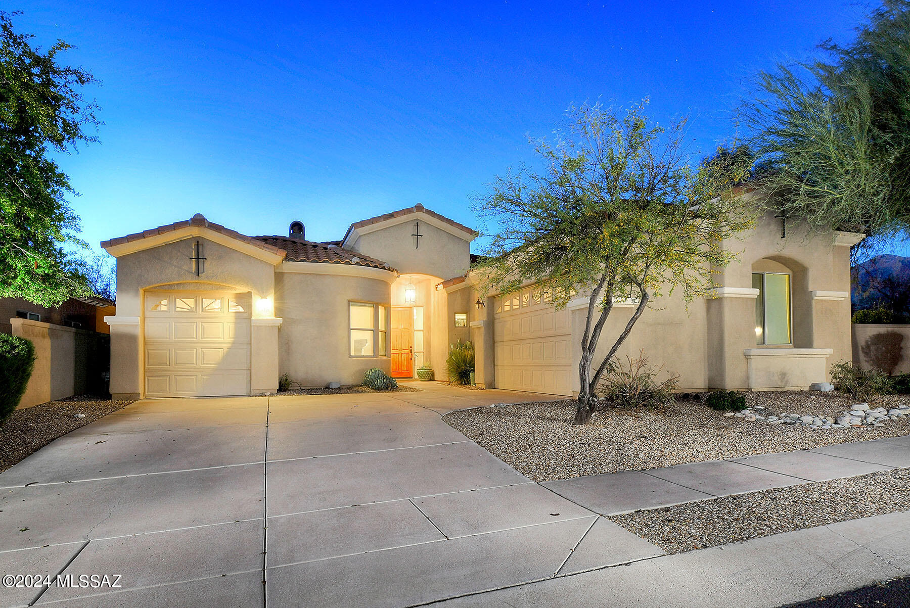 Stunning home featuresv3BR/3BA + Office in guard gated Villages of La Paloma on one of the largest lots, capturing unobstructed views of the Catalinas. Remodeled custom designed kitchen is a chef's delight, featuring gorgeous sleek cabinetry, top of line SS appliances, center island & granite countertops. French doors, from breakfast room, open to covered ramada complete w/ fantastic one-of-a-kind outdoor kitchen. Great room plan incl. gas fireplace, high ceilings, custom lighting & wall of windows bringing the outside in.  It accesses resort style backyard ideal for Tucson's outdoor lifestyle, featuring multiple flagstone patios, charming fountain, mature trees & lush vegetation. Spacious dining room w/ a built-in buffet & accommodates several guests. See MORE tab... The primary bedroom suite has a fireplace, large walk- in closet & opens to a private patio. Luxurious primary bath includes two separate vanities w/granite countertops, a walk-in shower as well as a soaking tub. Split bedroom plan could easily be used as guest quarters w/two additional bedrooms & a full bath, strategically positioned for optimal comfort. The 3 attached garages incl walls of built -in cabinets & provide an abundance of storage. 1 of the attached garage spaces is separate & could be used as a studio, workshop or to store your golf cart.  The community pool/spa & ramada are ideal for socializing with your neighbors. HOA includes garbage collection, street maintenance, pool/spa, guard gate + more. Conveniently located close to La Encantada shopping center which includes an upscale grocery store, several restaurants & shopping. See documents for La Paloma CC. Welcome Home!