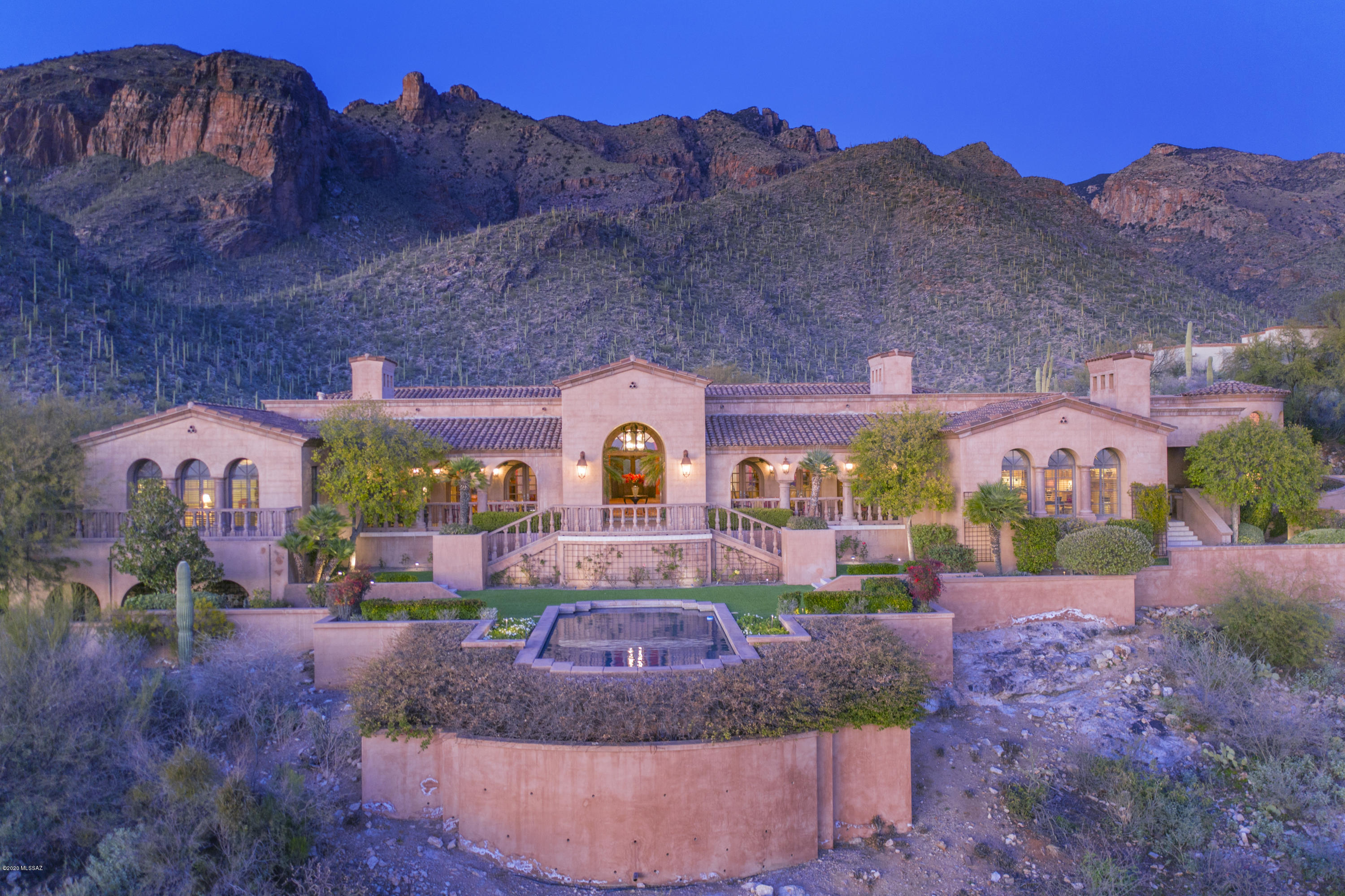 Stunning Hilltop Mediterranean Masterpiece Located in Tucson's Premier Gated Community, The Canyons. Dramatic 360-Degree Views w/ All 4 Mtn Ranges & Jaw Dropping City Views. Views from Every Window. Solid Masonry Home Captures the Old World Charm & Ambiance of Tuscany w/Integrated Color Stucco & Gorgeous Stone & Wood Flooring.Gracious Soaring Entry & Separate Reception Area w/ Views from the Front Door through to the Terrace & City below. There
is Gallery Space on Both Sides of the Formal Entry Designed for Art Display & Large Scale Entertaining & Seated Dining Easily Hosting 30-35 Guests. Beautifully Appointed Mirror-Image, Formal Living & Dining Rms Flank the Reception Area & Look Out to the Terrace, Pool & City Lights. Both Rms have Carved Stone Gas Fireplaces