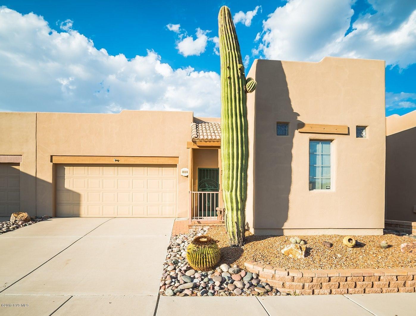 A tall Saguaro cactus stands guard within a river rock garden to welcome you to this quaint home with Southwestern Parapet roof lines and natural wood beam headers. The great room is capped with vast views of the 11th fairway of the Torres Blancas Golf Course through 3-panel patio doors. The open floor plan allows conversations to flow freely between the great room, open dining area and the kitchen. Pastel desert tones permeate the galley style kitchen where you'll find decorative cabinetry, bountiful counter space and an easy clean glass cooktop range. Double doors take you into a quiet den which can be used to keep up your computer work. The master bedroom has twin cross breeze windows adorned in a peaceful blue paint tone. And, your master bath offers dual sinks and a generous  walk-in closet. Step outside to enjoy swaying palm trees, mesquite trees, desert landscaping and green fairways that will enrich your views as you relax on your covered patio with its extended brick pavers.