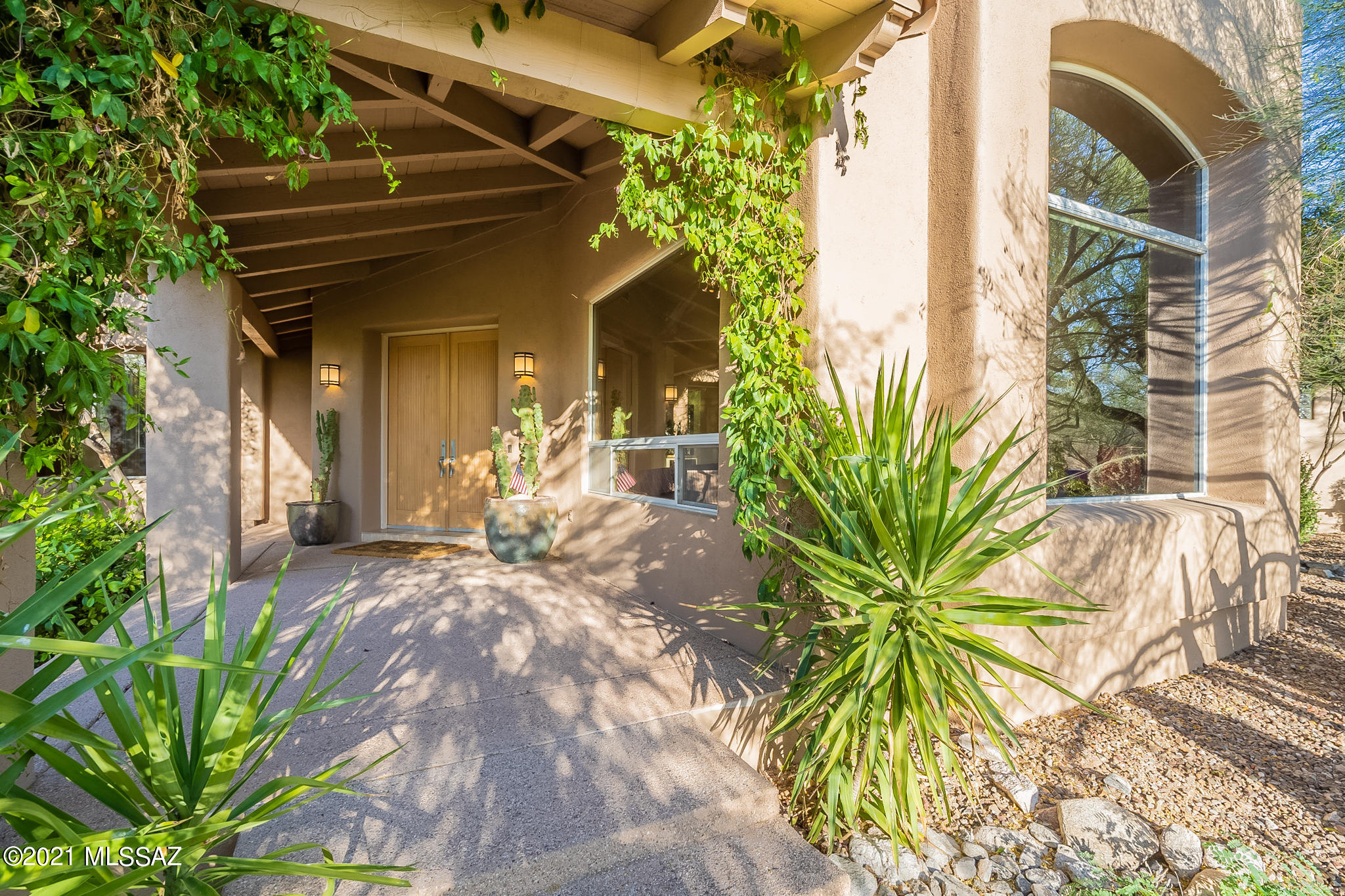 Custom home on 1.1 acres in the prestigious guard gated La Paloma Estates. This open, contemporary home is 4,356 sqft & the 5 bd/5 ba  offers flexibility for the way you live. Clean lines & architectural interest draw you in. Travertine floors throughout w/ bamboo flooring in bdrms. The guest wing offers game room, wet bar, 1 bdrm w/private deck, full bath & gym. The guest wing can be closed off from the main home & has private access to backyard. Relax under the large covered patios, or take a dip in the sparkling heated pool & spa w/waterfall. The outdoor kitchen has built in BBQ, hood, sink & refrig. There is even real grass for play & pets. Privacy & Catalina mountain views top off your own private retreat. The 3+ car garage has extensive built-in cabinets & AC!