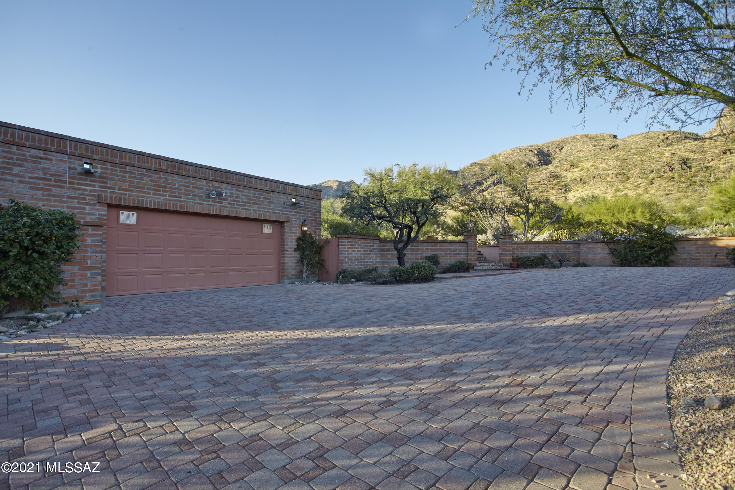 Sitting at the base of the Catalinas in the beautiful, manned gated community Sin Vacas, this home is situated in a lovely setting.  At a high point in the neighborhood, the lot offer big views of the mountains to the north and city lights to the south, all surrounded by lush desert vegetation.  The burnt adobe structure and brick patios exude character and authenticity.  A single owner property built in 1986, the home remains in original condition and is ready to be reimagined.  The one level split floor plan features 3 bedrooms, an office, 2 Â½ baths and generous living spaces spread over 3,539 sq ft.  Windows and sliding doors let in light and connect the indoors with the outdoors. An expansive covered patio adds usable space, outdoor dining and the perfect setting to take in Tucson's gorgeous sunsets.  Ample outdoor space remains available to amend the hardscape or add a swimming pool.

The Catalina Foothills location can't be beat.  Within 5 minutes you will find La Encantada, shopping, great restaurants, and local art galleries.  Within 10 minutes you will find Whole Foods, Tohono Chul gardens and multiple trailheads with outstanding hiking.  University of Arizona is a 20-minute drive.