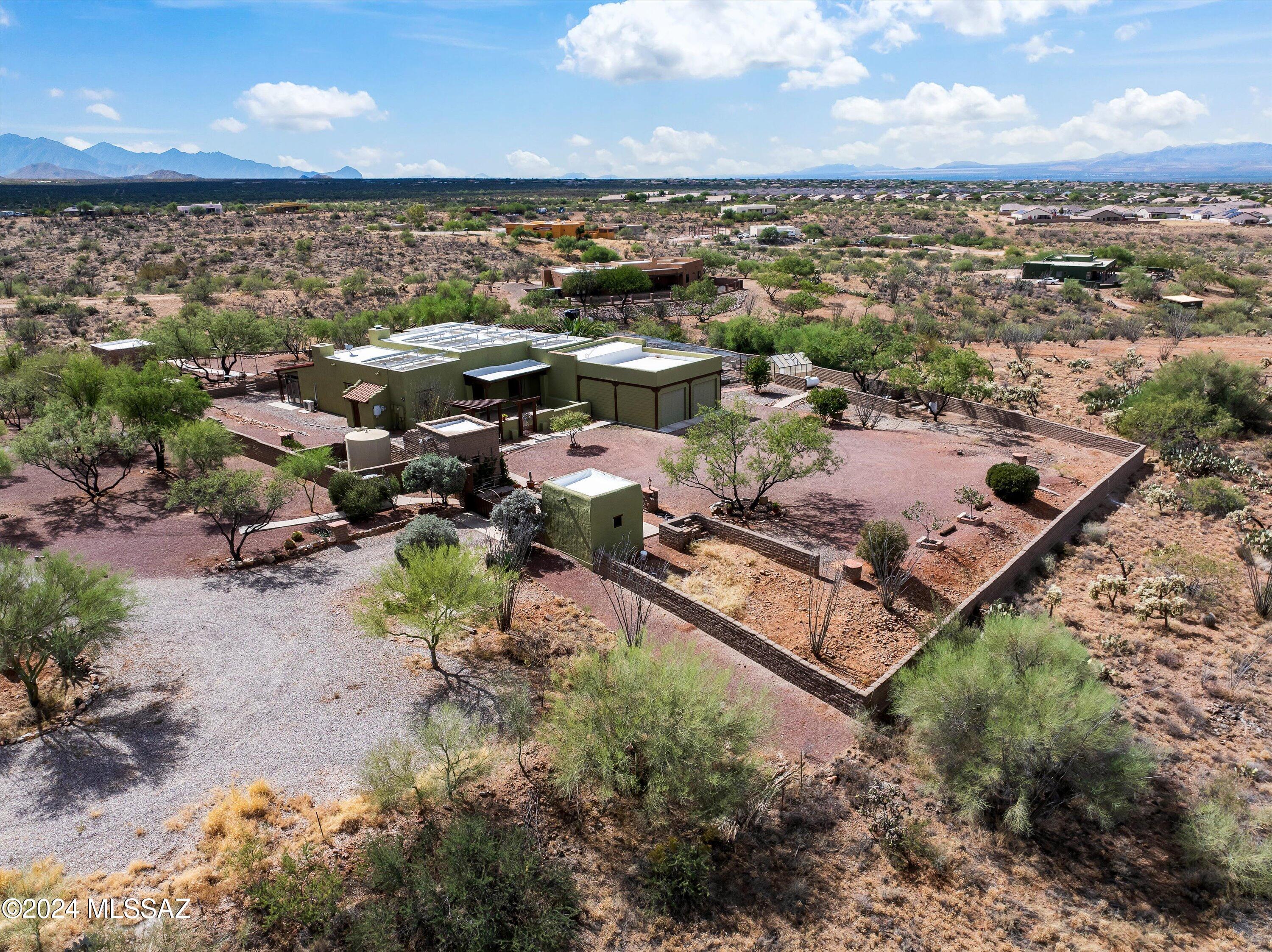 This is a rare opportunity to own a one-of-a-kind, full adobe estate, built by the original owner and showcasing authentic Southwestern Spanish style. This 3 bed (+Den), 2 bath, 3,070 sqft home is truly unique.  Set on over two acres—with the potential to subdivide—the sale also includes adjoining parcel 305-31-0040. The property features newly replaced roofs with a transferable warranty, an overproducing private well, owned solar, a septic system, and sweeping panoramic views. Inside, the home boasts vaulted ceilings, exposed wood beams, and a charming wood-burning fireplace, offering the warmth of a mountain retreat. The den includes a build-in Murphy bed! All the appliances were replaced in May 2024 including the washer are dryer, home also includes SimpliSafe Security System,. The expansive grounds are ideal for gardening enthusiasts, with many fruit trees, a new irrigation system, and six raised garden beds currently yielding fresh vegetables