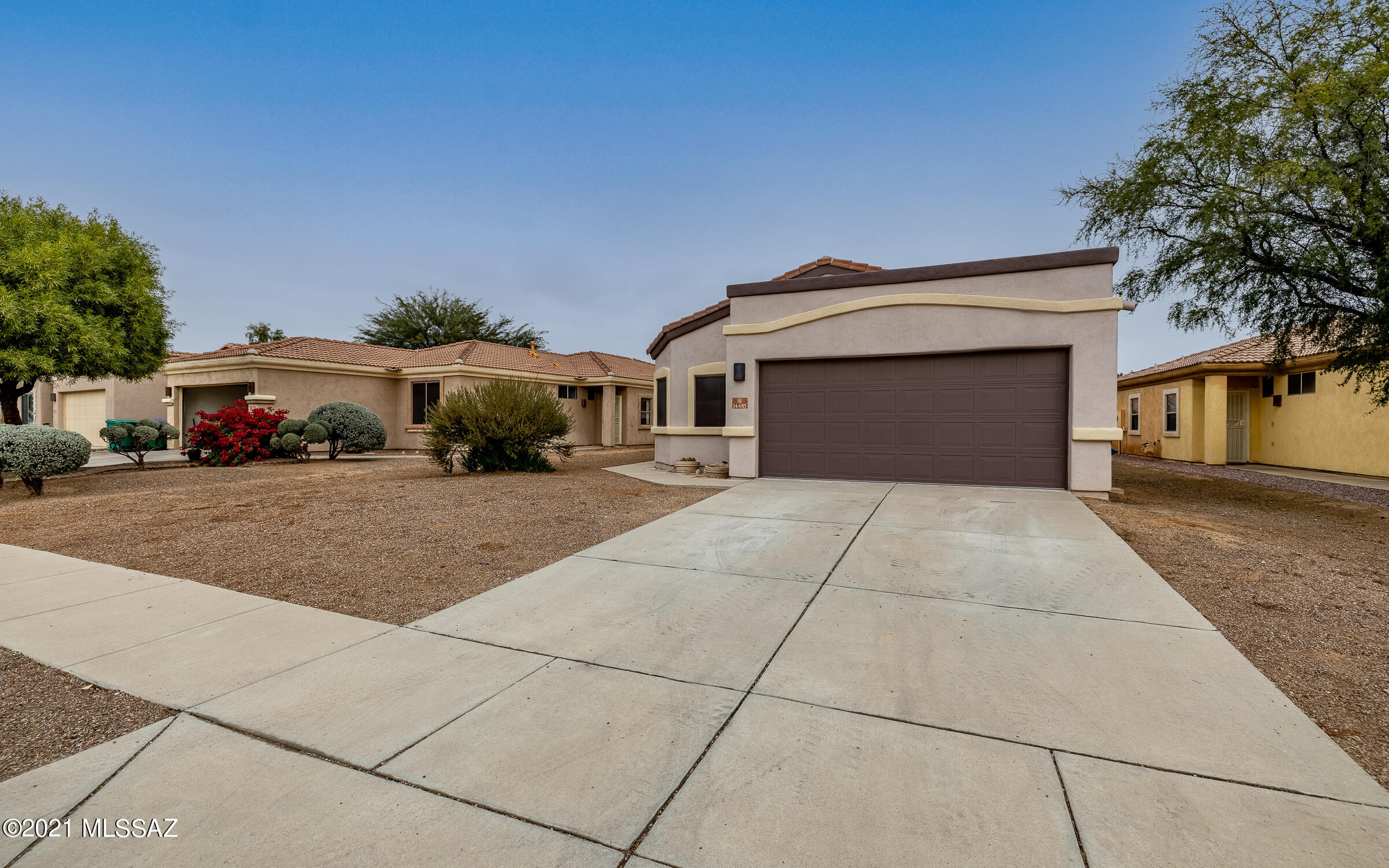 This stunning 4 bed home has an extra long driveway, two car garage, on a sizable lot w/no immediate neighbors behind (wash borders). The interior home has been freshly painted, including the garage! The open floor plan w/soaring ceilings makes the home feel very spacious.  You'll love the tile throughout, except the bedrooms. The home boasts ceiling fans & window coverings.  The kitchen has exceptional counter & cabinet space w/a pantry AND stainless steel appliances!! The owner's suite is HUGE w/an equally impressive walk-in closet & roomy bath, complete w/a double-sink vanity, shower, garden tub, & separate water closet. Backyard has a covered patio. The community has several parks, swimming pools, spas, lake, basketball & tennis cts, walking trls, rec & exercise facility. WATCH VIDEO!!