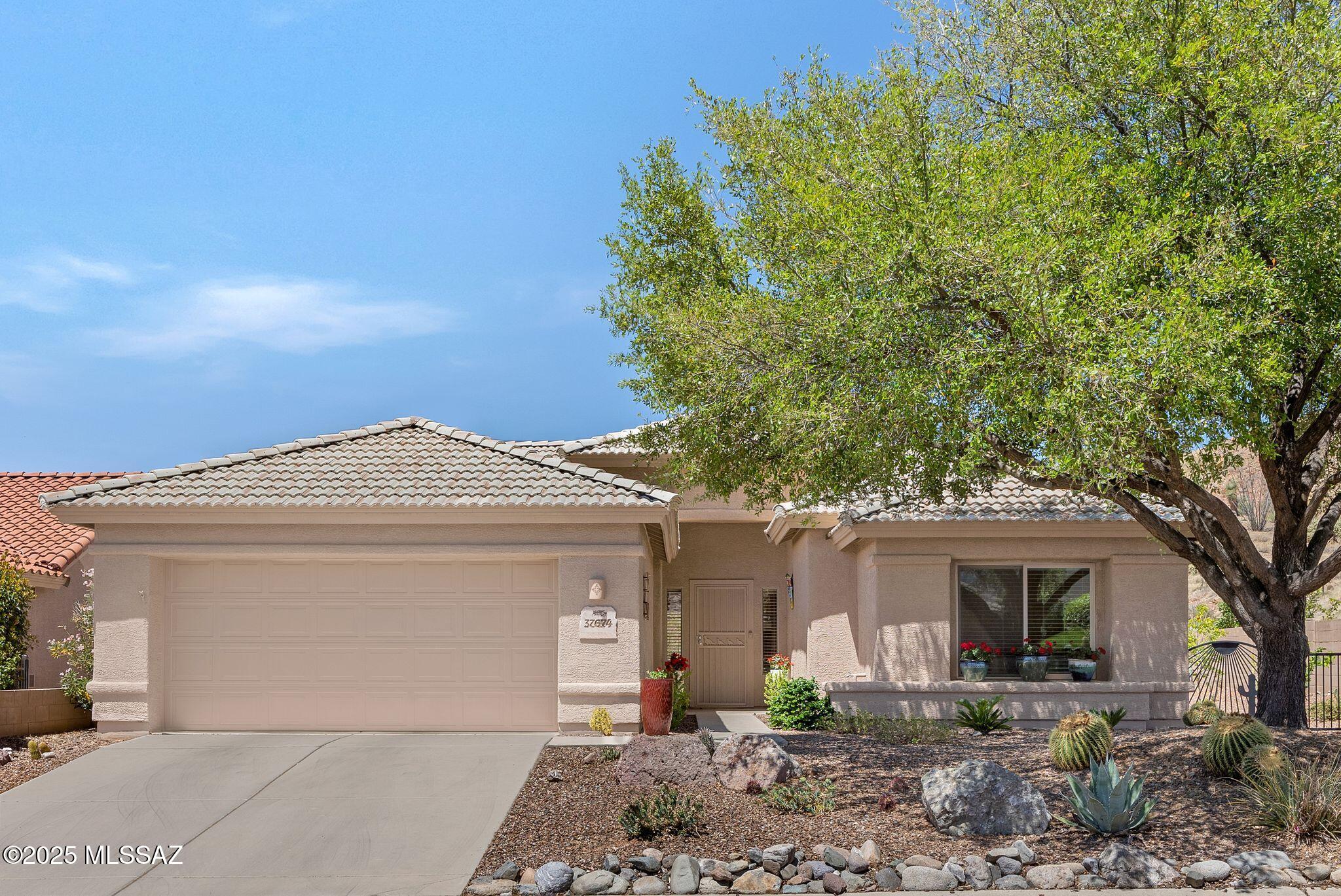 Updated Chaparral with No Homes Behind except Nature! Open Concept Living! Spacious Great Room with built-in Entertainment Center. Dining Area with Slider to Patio. Gorgeous Kitchen with Granite Counters, Stainless Steel Appliances, Island & Custom Cabinetry. Owner's Suite has Owner's Bathroom with Barn Door, Custom Cabinet, Granite Counter, Walk-in Shower & Walk-in Closet. Den/Office with frosted Glass French Doors. Guest Bedroom with Closet. Updated Bathroom with tiled Walk-in Shower, Granite Counter & custom Cabinet nearby. Laundry Room has W/D & Cabinets. 2 Car Garage has 2024 HVAC, 2022 W/H, & 2 Metal Cabinets. 2020 Irrigation System. Covered Paver Patio has Firepit Table with 4 Chairs & extended Paver Patio for entertaining. Lovely Landscaping, Fruit Trees & Gated Yard to enjoy!