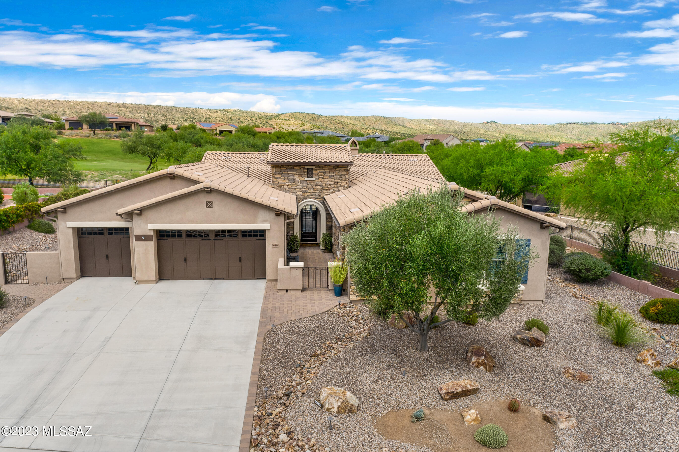 Luxury living on The Preserve golf course with unobstructed mountain views. Pristine Acacia with casita is ''better than new''. Beautiful wood-look tile flooring throuhout. Creamy white kitchen with Cambria Quartz counters and full height tile backsplash. Monogram appliances, Advantium microwave, gas cooking with stainless hood vent. Upgraded cabinets with roll out shelves. Porcelain ''Apron front'' single bowl sink. Open great room features a gas fireplace with granite surround and wood accent wall. Built-in media center includes TV, 5 ceiling speakers & audio equipment. Double sliding glass doors open to the covered patio with auto screen and TV ready wall. 4 Ft extension on the garage. Water softener, utility sink and storage cabinets. Fenced backyard with waterfall & pond. Located on a quiet non-through street with golf course across the street in the front and on the 13th fairway in the back.
5 Ft extension on the den. 4 Ft extension on the 3 car garage.
Kitchen has built-in wine cooler/beverage refrigerator.
Walk-in pantry.
Space in utility room for freezer.
All bathrooms have Quartz top vanities and wood frame mirrors.
Wood-look tile throughout the house with Carpet in guest BR and casita.
2 gas stubs on patio.
Green Egg BBQ is included
