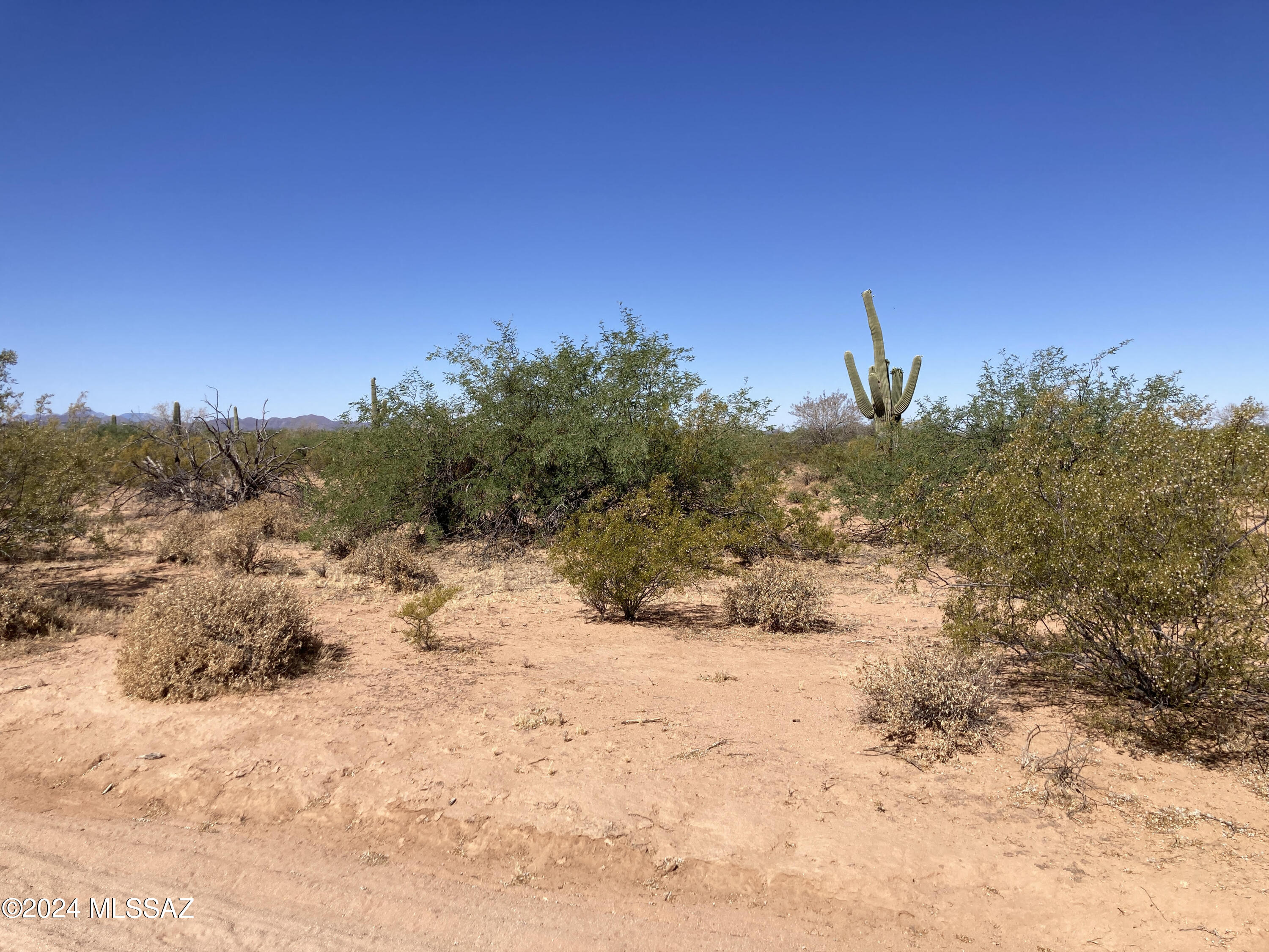 Level, pristine desert landscape - smooth dirt roads in area, corner 5+ acre lot for site built or manufactured home.  Quiet area great homesite.