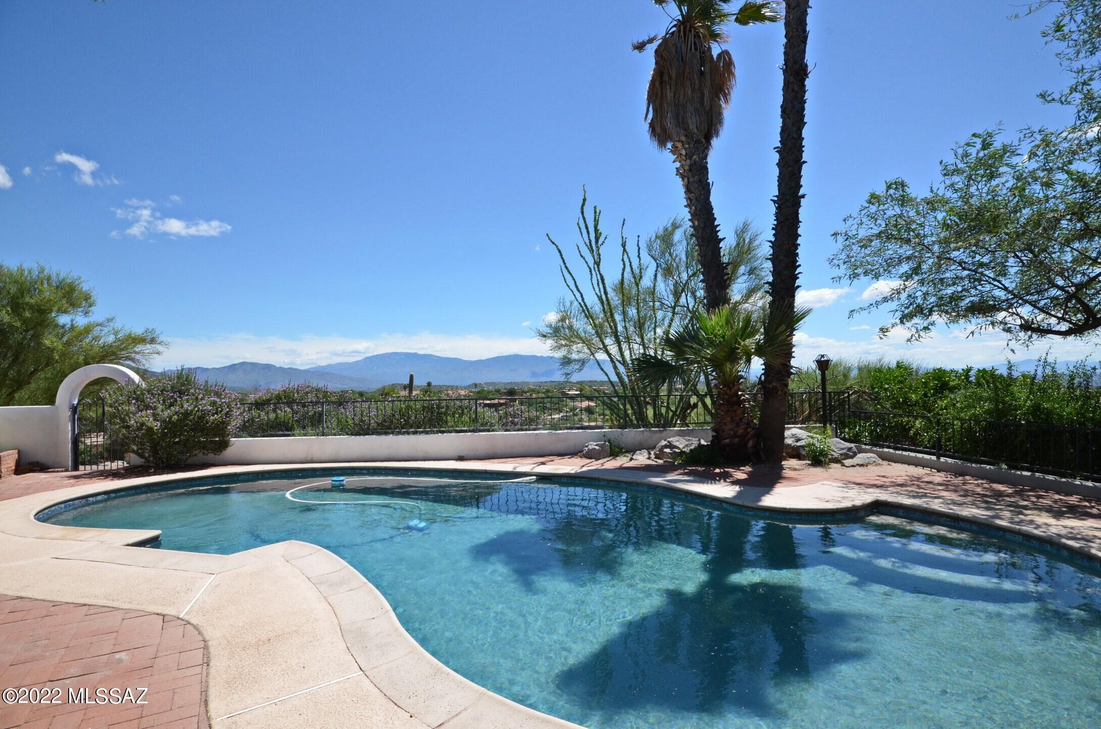 Significant price adjustment! Set on an idyllic perched lot, this METICULOUSLY renovated light and bright 4 bedroom with office, 3.5 bathroom home has charm and is perfectly oriented to maximize the 360 degree Mountain and City views!   The Great Room is your home's centerpiece; extending from front to back, with floor to ceiling windows, that overlook outdoor entertaining areas, a sparkling pool as well as mountain AND city views beyond!   The expansive open kitchen features contemporary cabinetry, Quartz counters, stainless steel appliances, a large center island that seats 4, a walk-in pantry and views every which way you look!  The primary suite is a private retreat with its French doors that open to a large balcony where you can delight in your morning coffee and your view! The en-suite bathroom features a double vanity with quartz counter, a spa-like shower, walk-in closet and views.  Bedroom #2 maximizes mountain views with French doors that open to a Juliette balcony.  Spacious en-suite bedroom #3 is perfect for guests.  Bedroom #4, with it's built in bookcase, is home office ready.  And bedroom #5 with it's large closet can be leveraged as a second home office or intimate den.  Flooring throughout consists of contemporary ceramic "wood plank" tile.  Low maintenance outdoor hardscaped spaces, mature landscaping and covered patios beg for you to sit and take pleasure!  Additional property details are included in the Property Highlights document.  This property, a lovely blend of Spanish Mission with contemporary updates, is indoor/outdoor living at its finest!